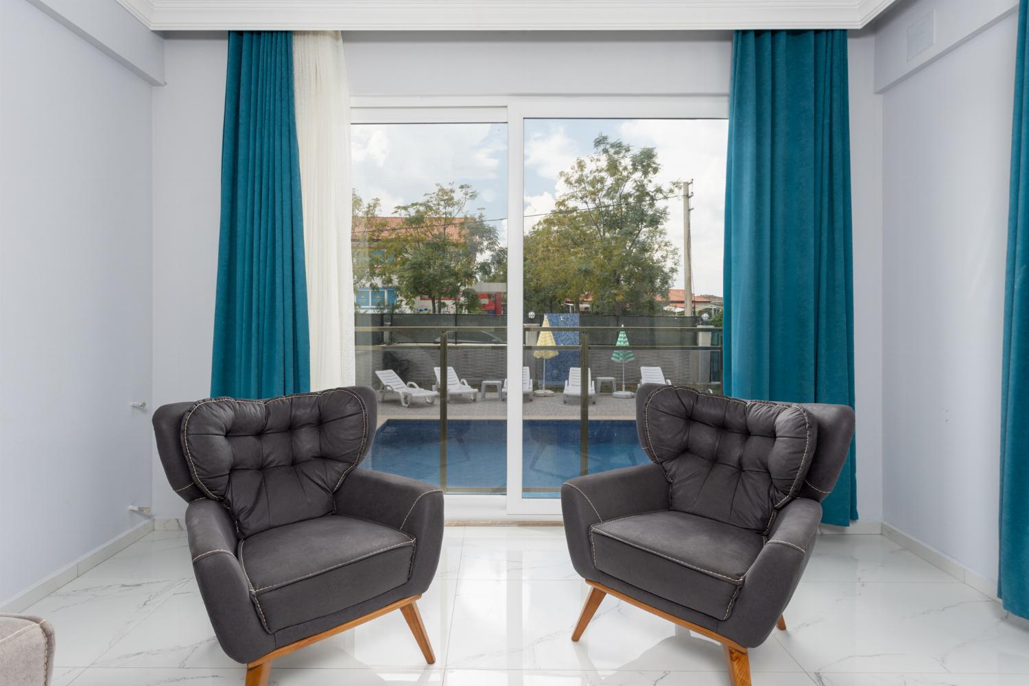 Living room with sofas, A/C, WiFi internet, and satellite TV