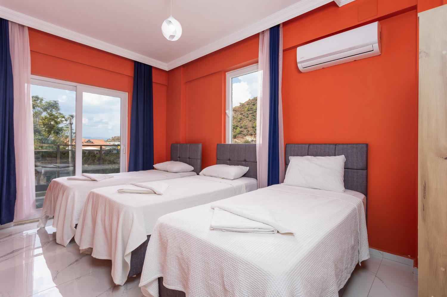 Bedroom with three single beds, and A/C