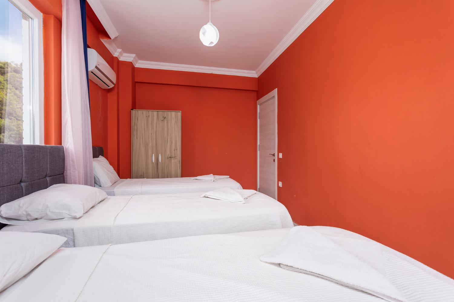 Bedroom with three single beds, and A/C