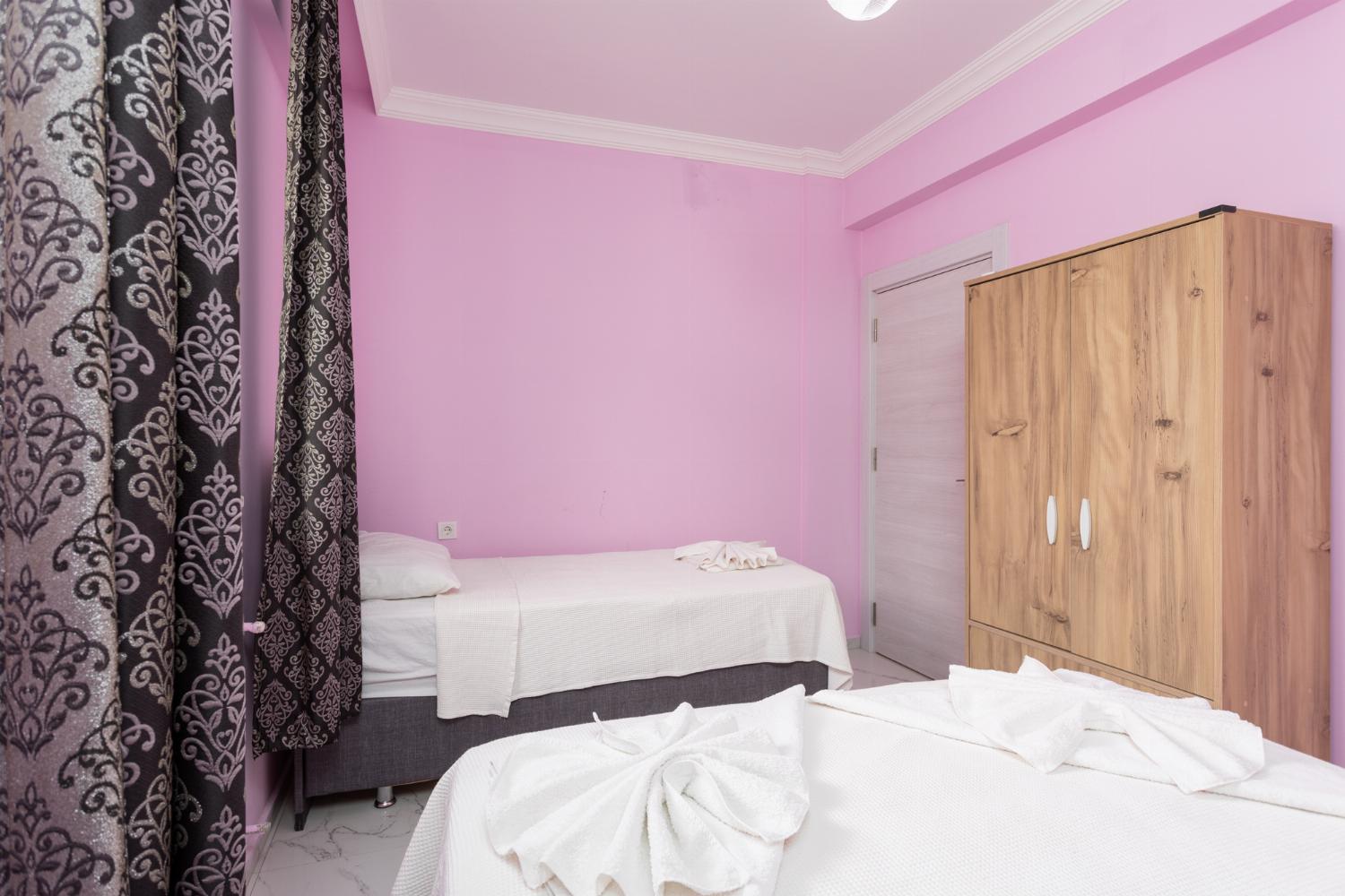 Bedroom with double bed, single bed, and A/C