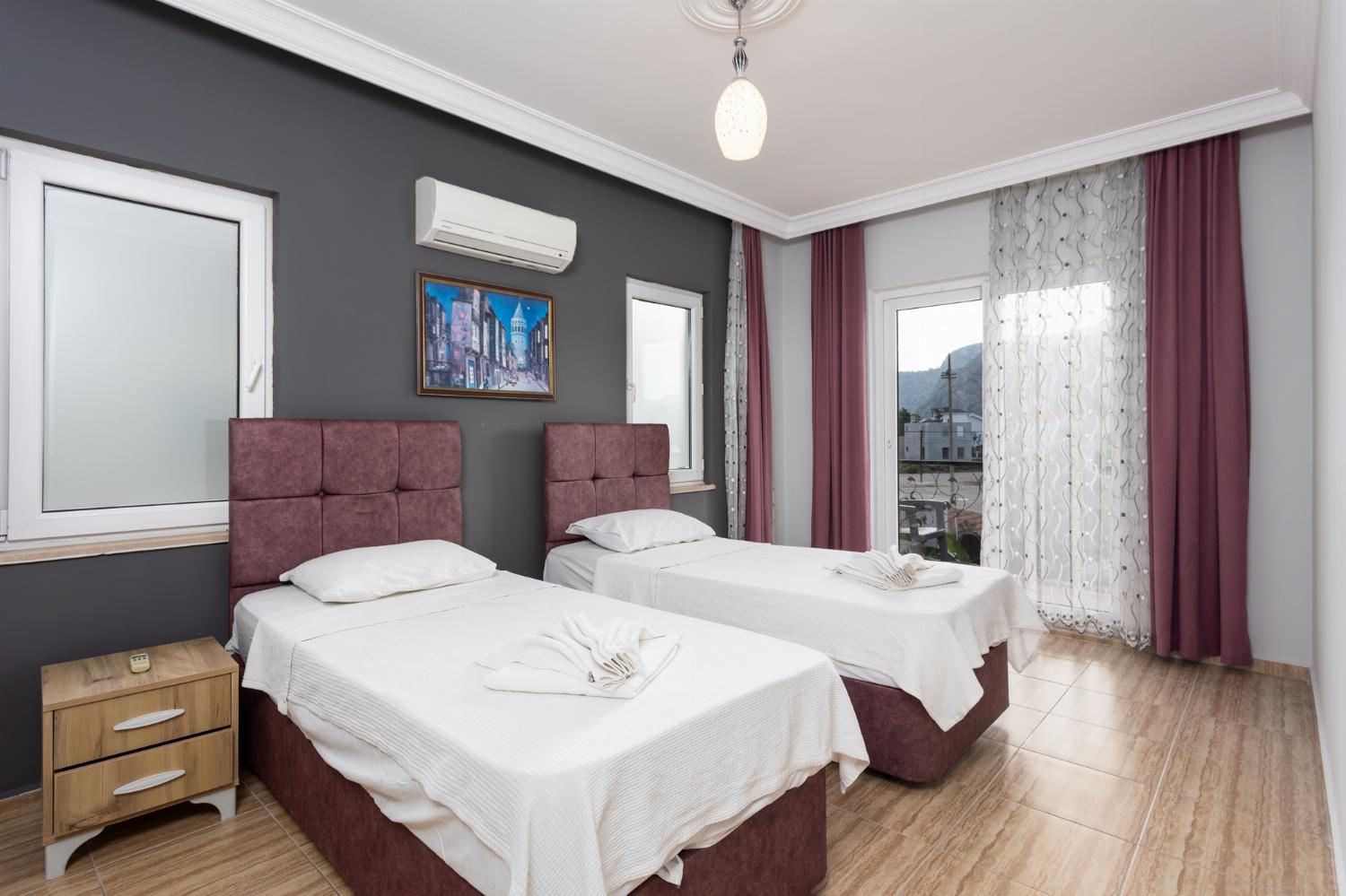 Twin bedroom with en suite bathroom and A/C