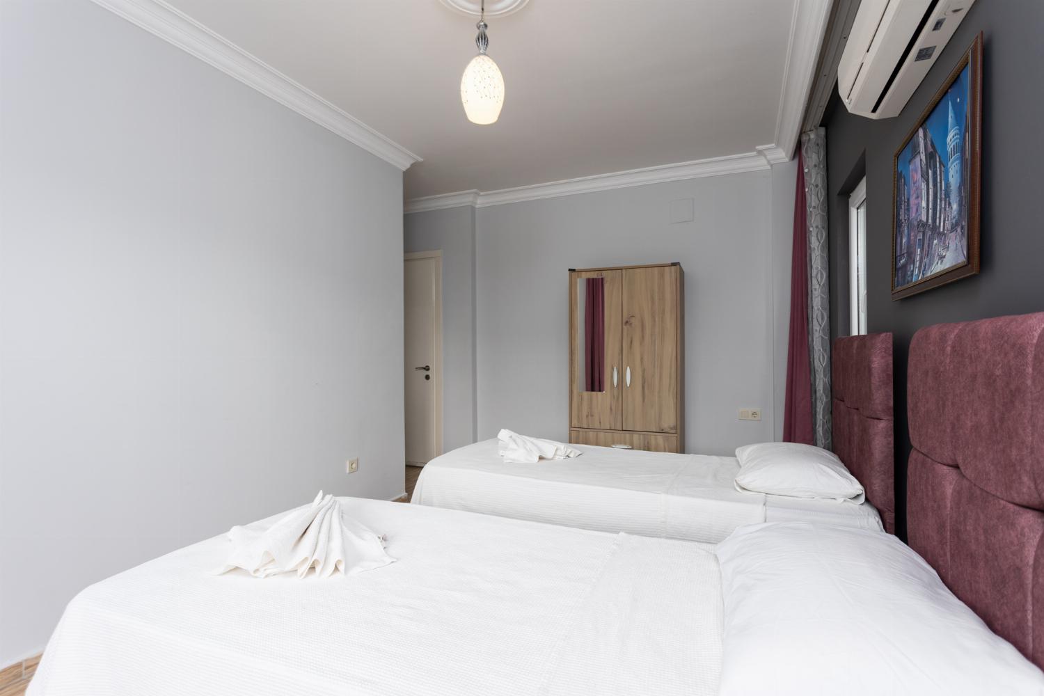 Twin bedroom with en suite bathroom and A/C