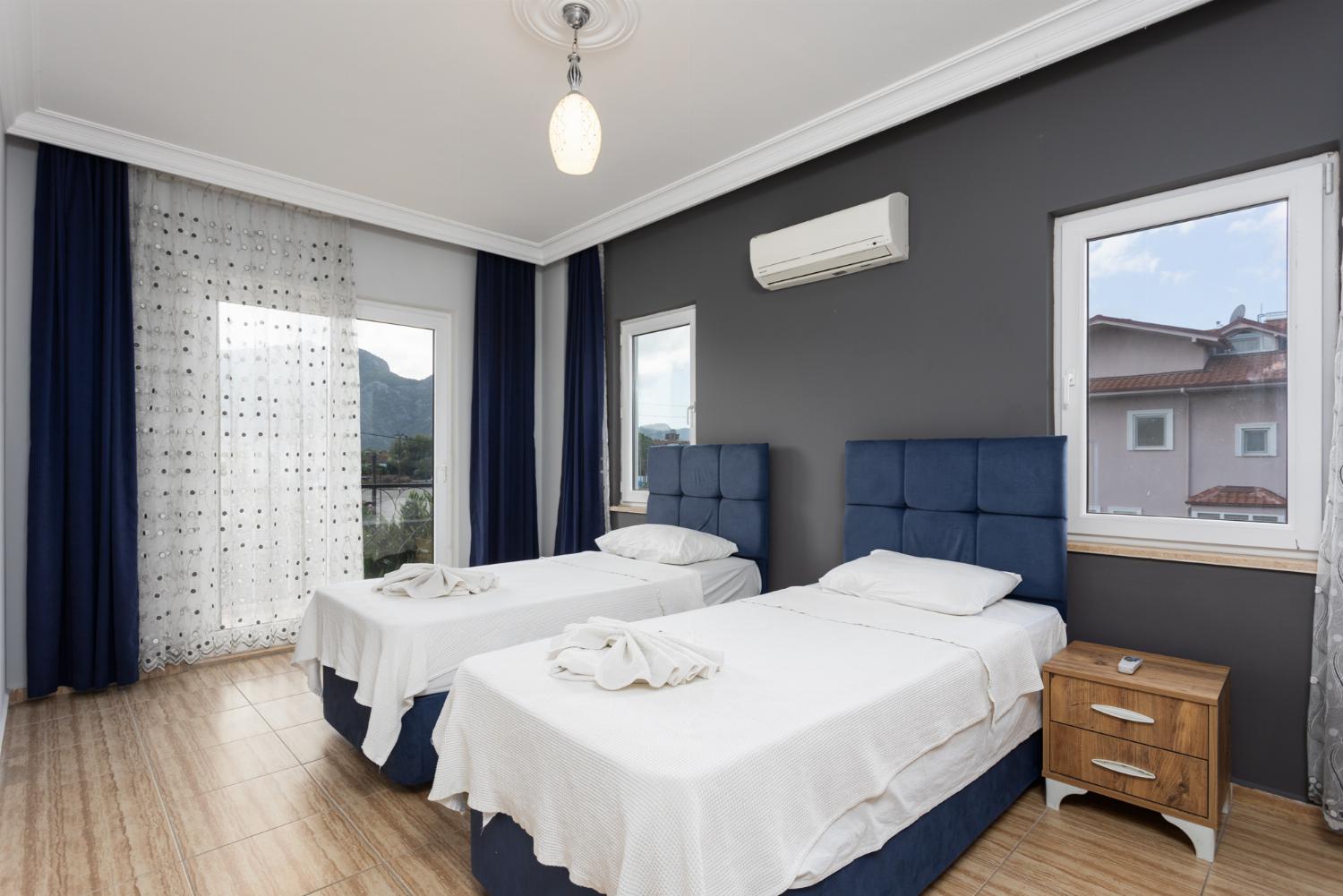 Twin bedroom with en suite bathroom and A/C