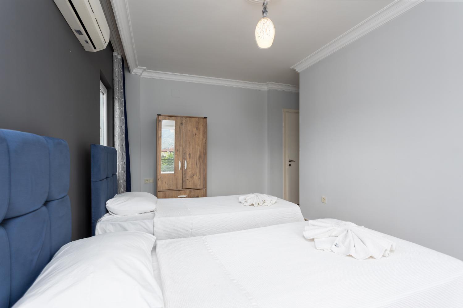 Twin bedroom with en suite bathroom and A/C
