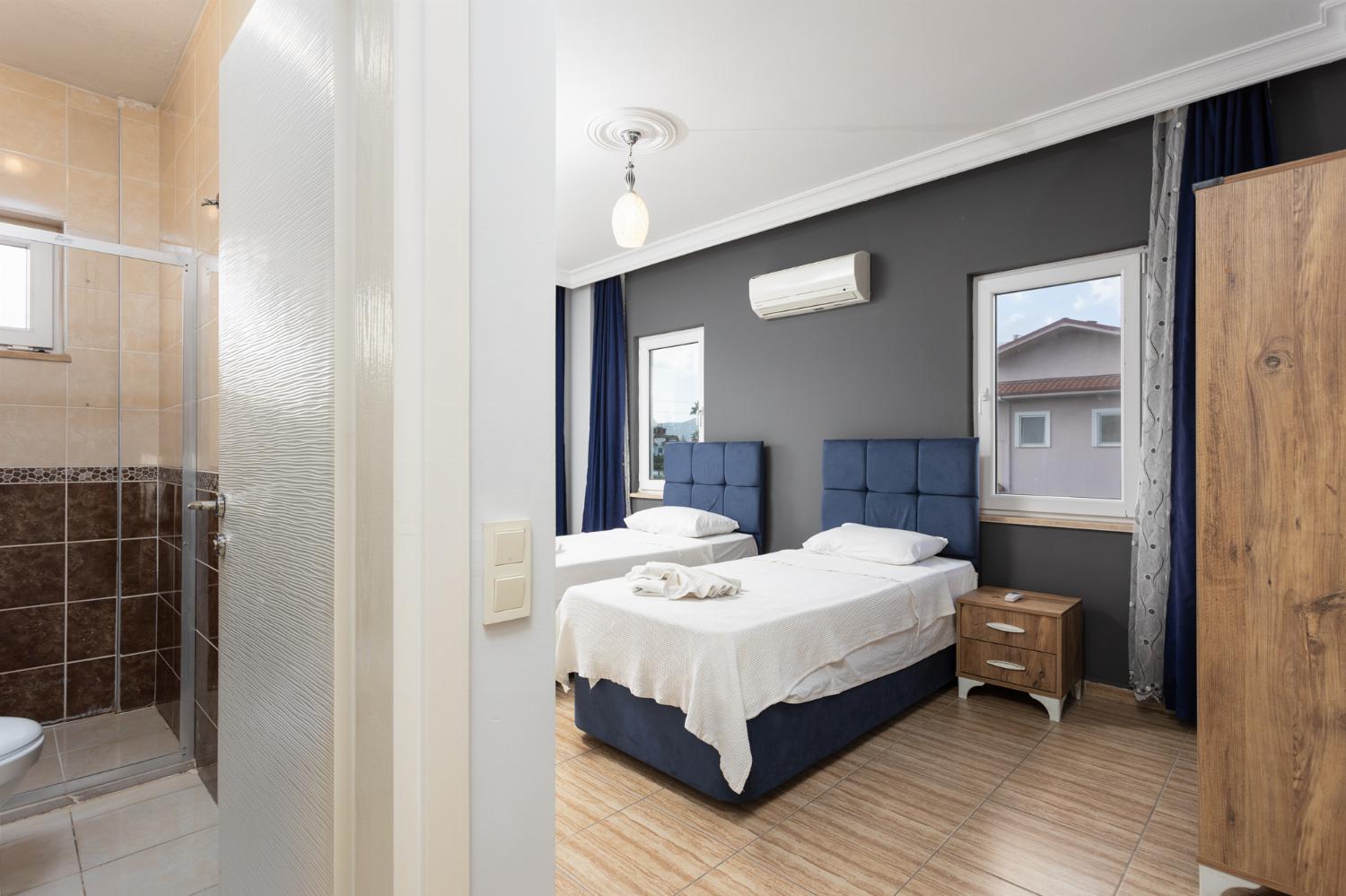 Twin bedroom with en suite bathroom and A/C