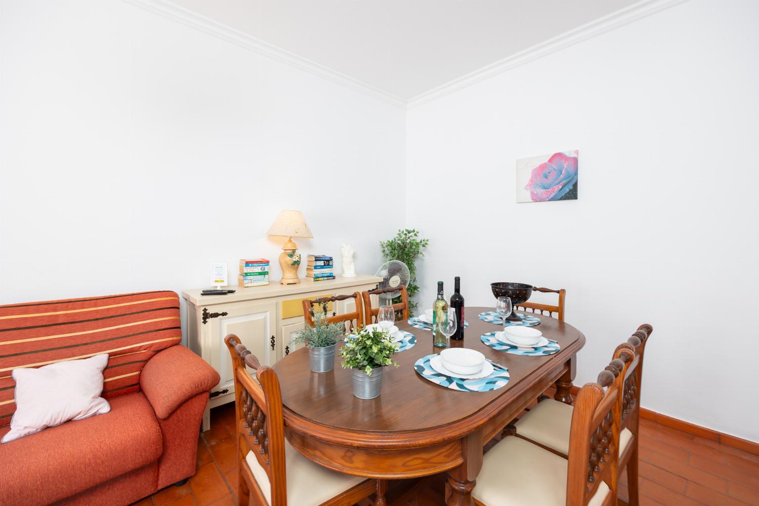 Living room with sofa, dining area, ornamental fireplace, WiFi internet, and satellite TV
