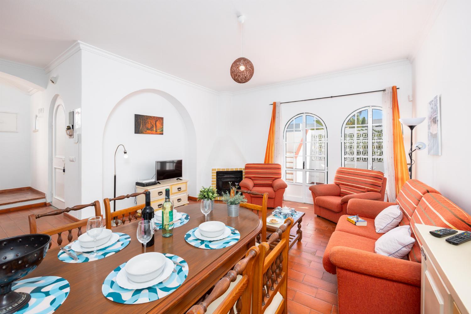 ,Living room with sofa, dining area, ornamental fireplace, WiFi internet, and satellite TV