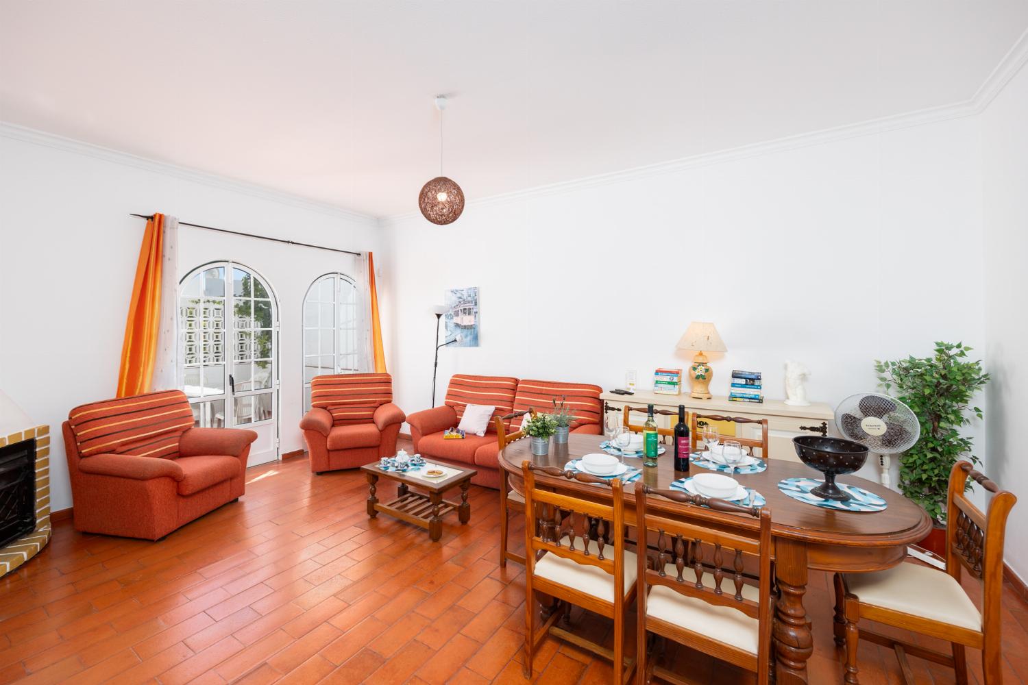Living room with sofa, dining area, ornamental fireplace, WiFi internet, and satellite TV