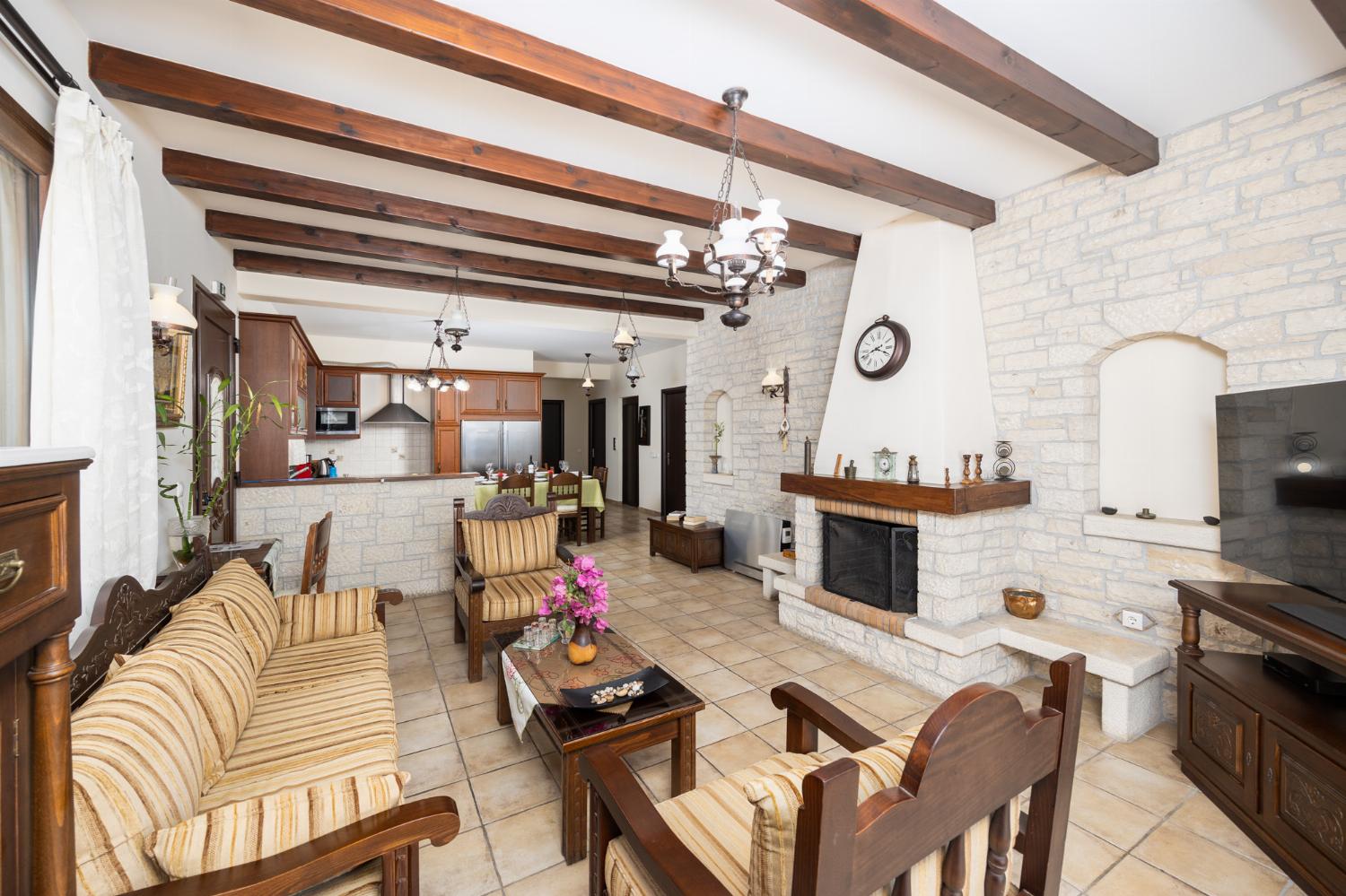 Open-plan living room with sofa, dining area, kitchen, ornamental fireplace, A/C, WiFi internet, satellite TV, and sea views