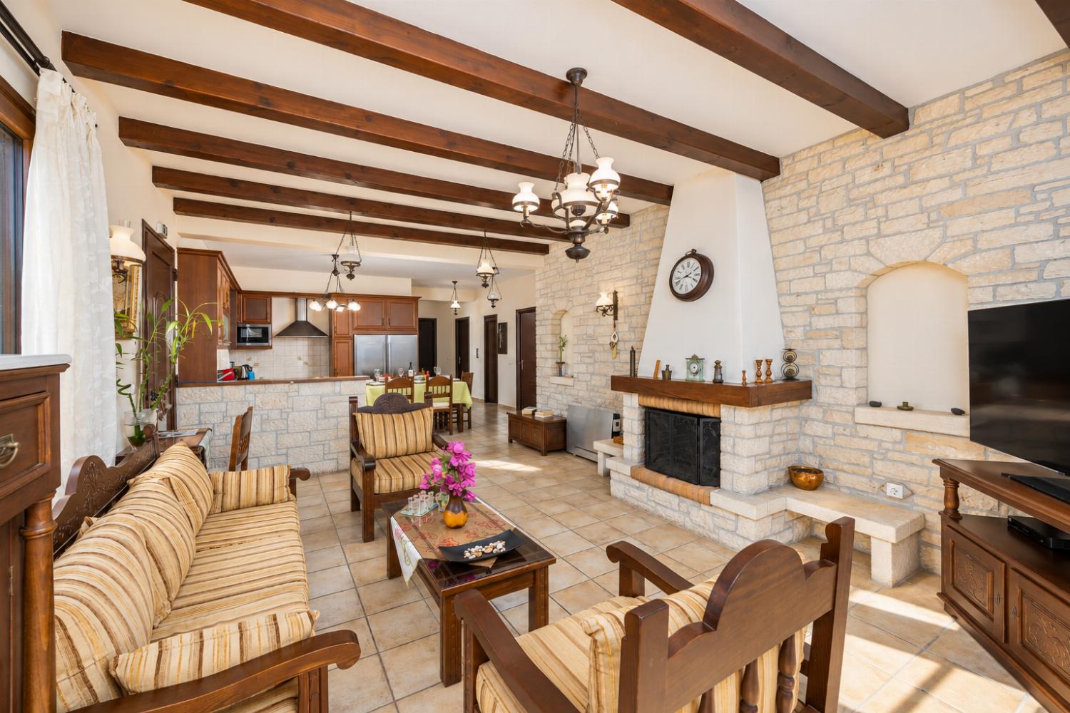 Open-plan living room with sofa, dining area, kitchen, ornamental fireplace, A/C, WiFi internet, satellite TV, and sea views