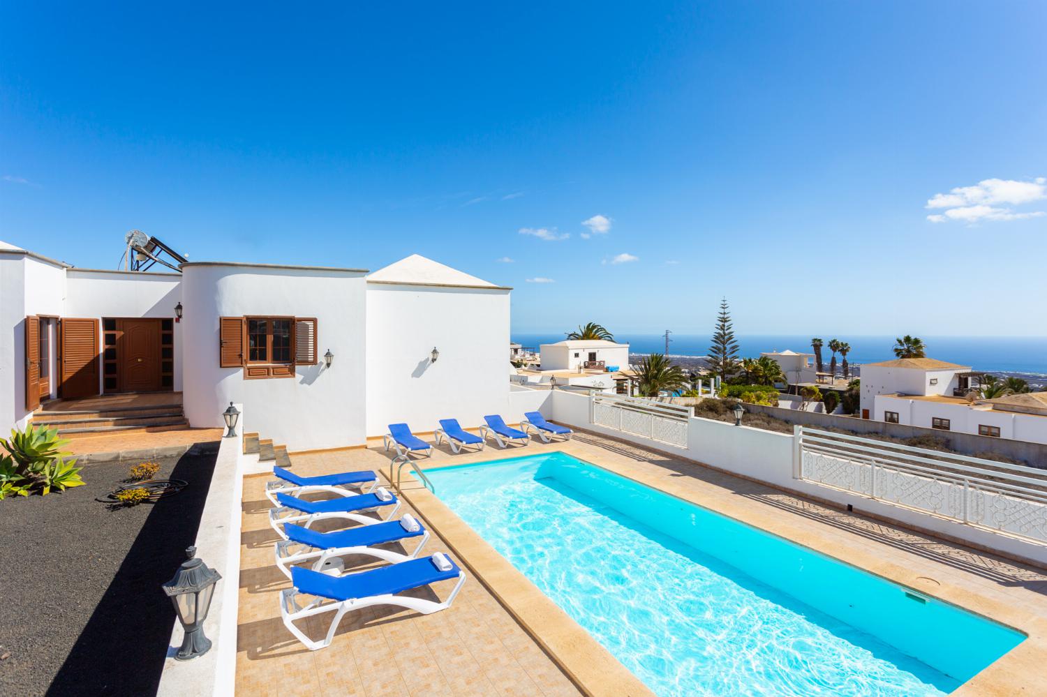 ,Beautiful villa with private pool, terrace, and garden with sea views