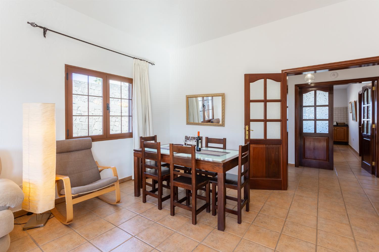 Living room with sofas, dining area, A/C, WiFi internet, and satellite TV