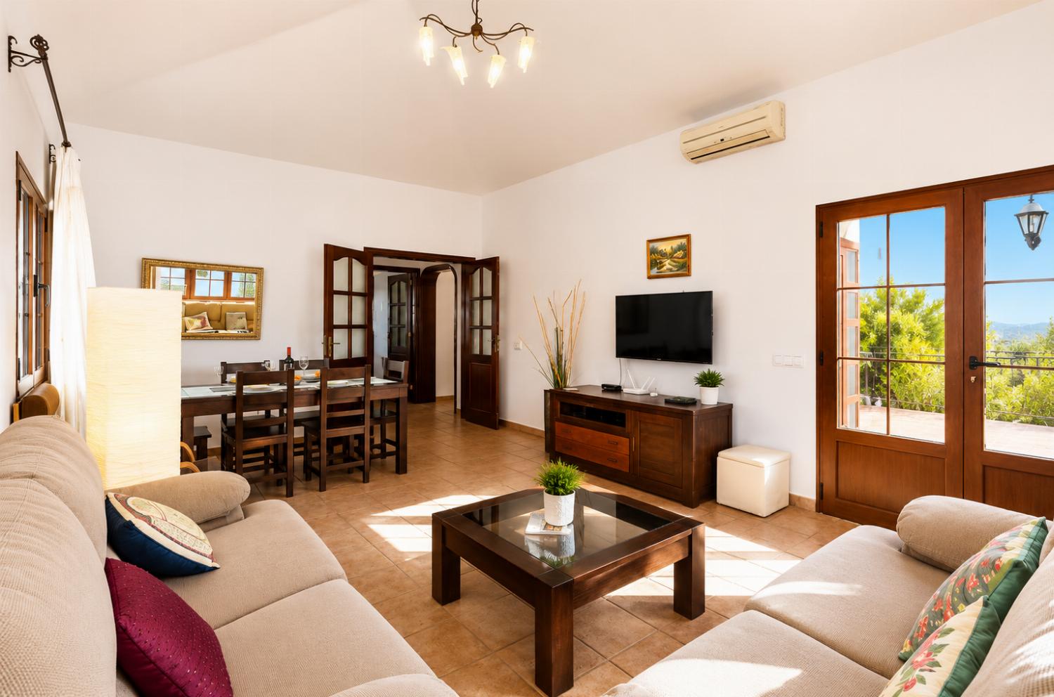 Living room with sofas, dining area, A/C, WiFi internet, and satellite TV