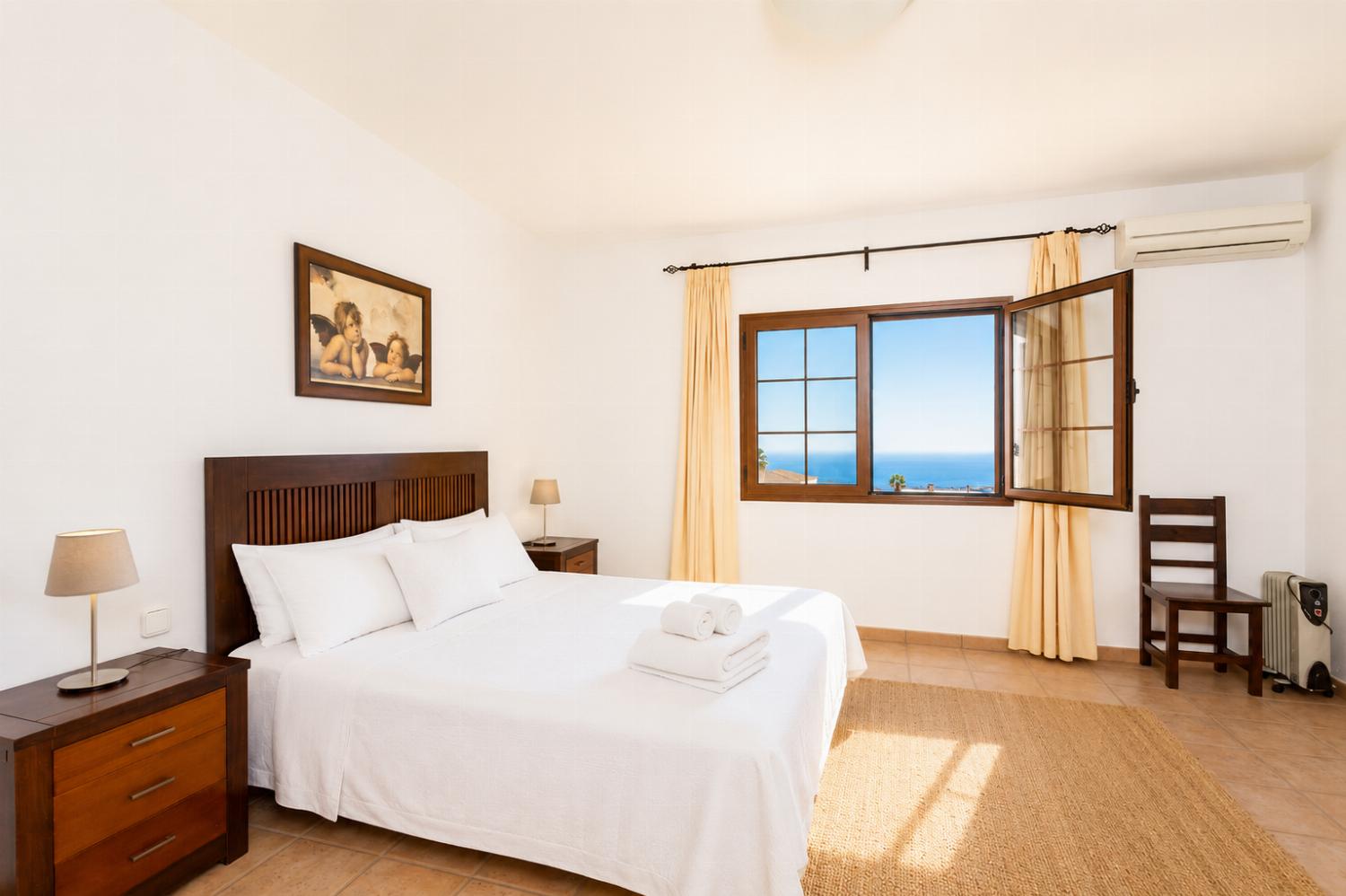 Double bedroom with en suite bathroom, A/C, and sea views