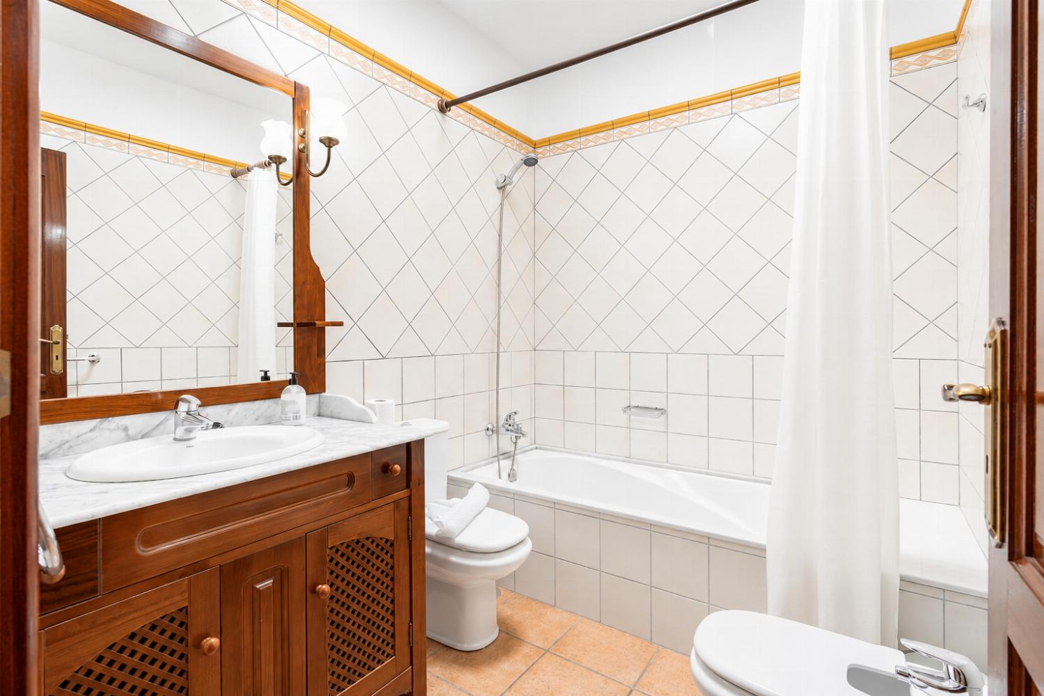 Family bathroom with bath and shower