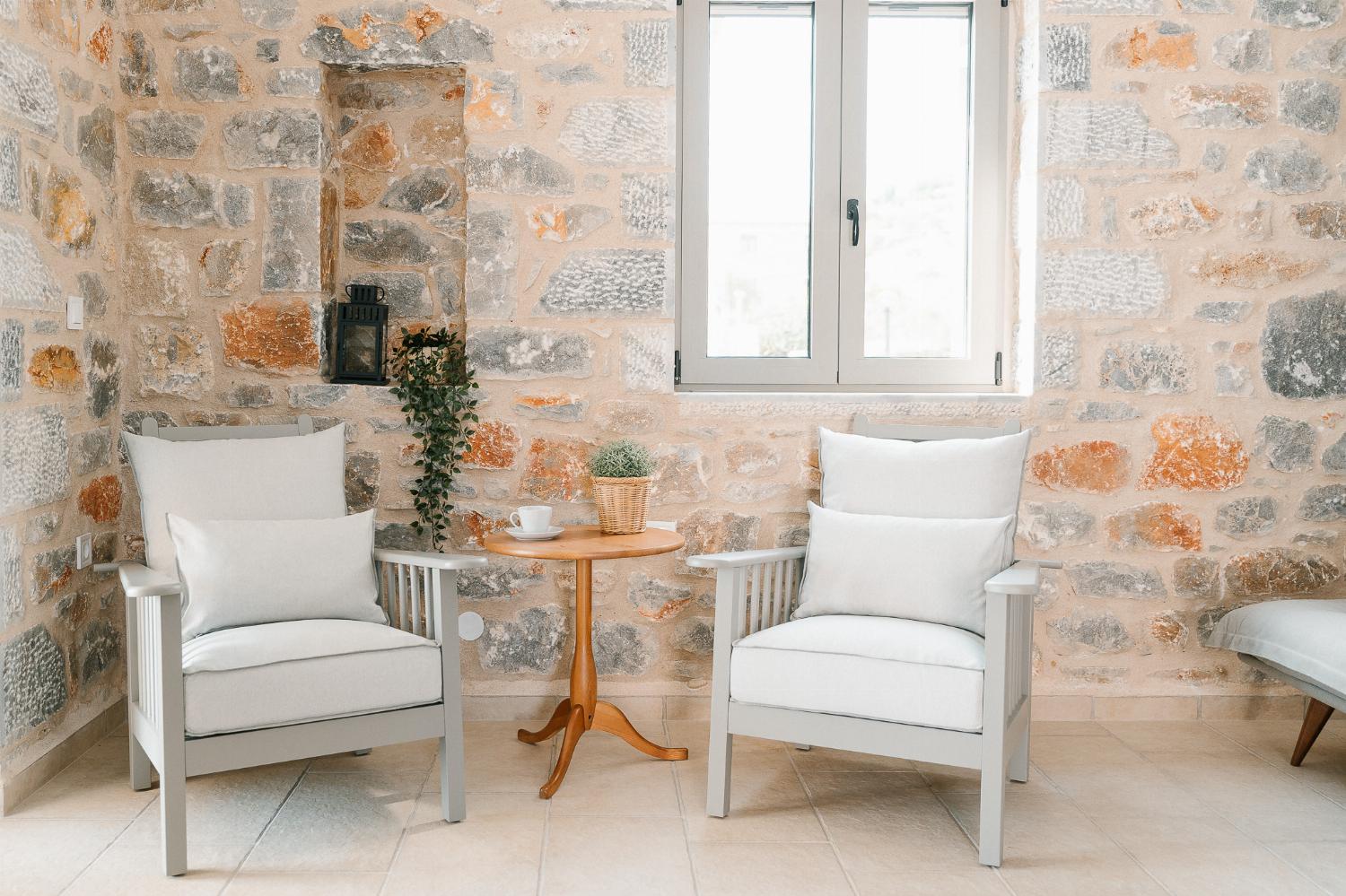 Open-plan living room with sofas, dining areas and kitchen