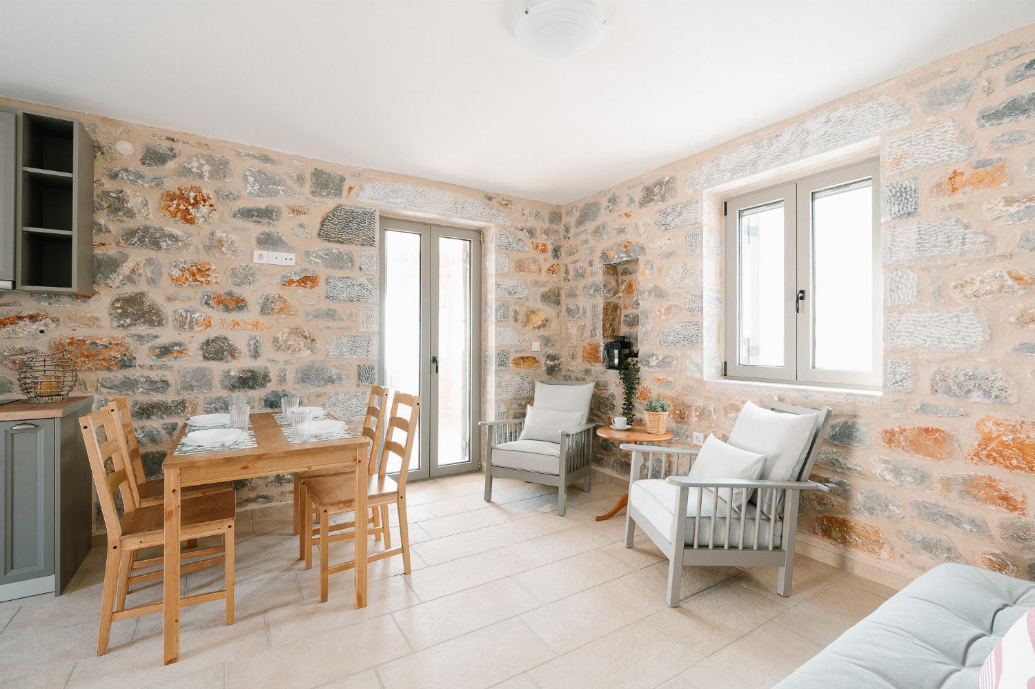 Open-plan living room with sofas, dining areas and kitchen