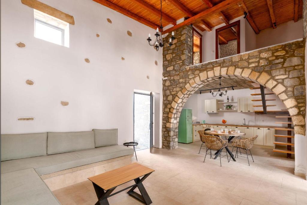Open-plan living room with sofas, dining areas, kitchen