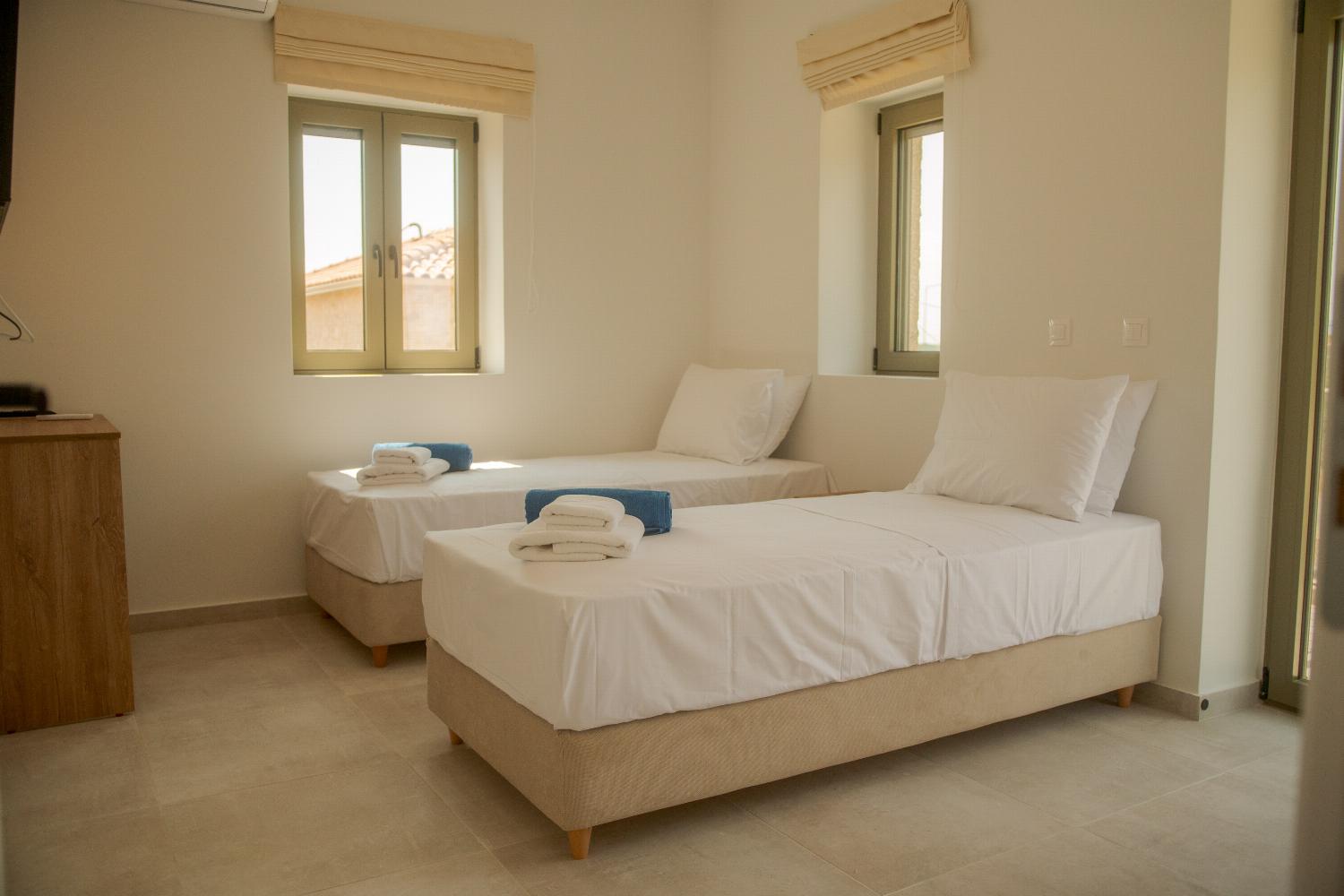 Twin bedroom with TV and A/C
