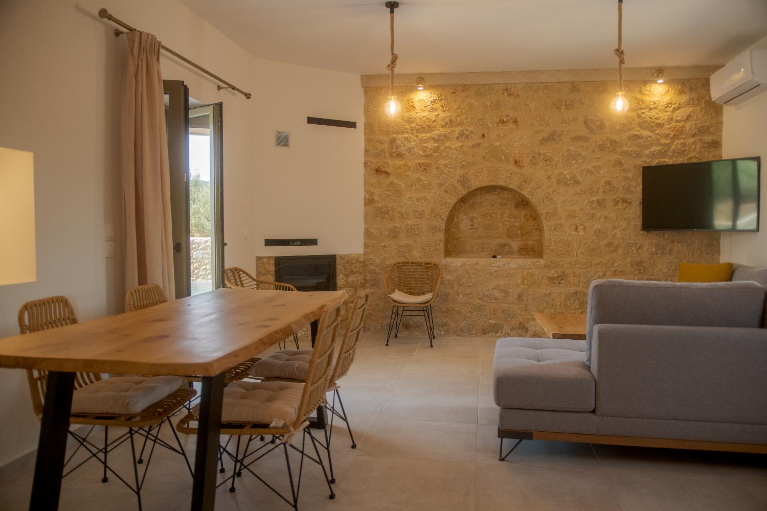 Open plan living room and dining area with TV