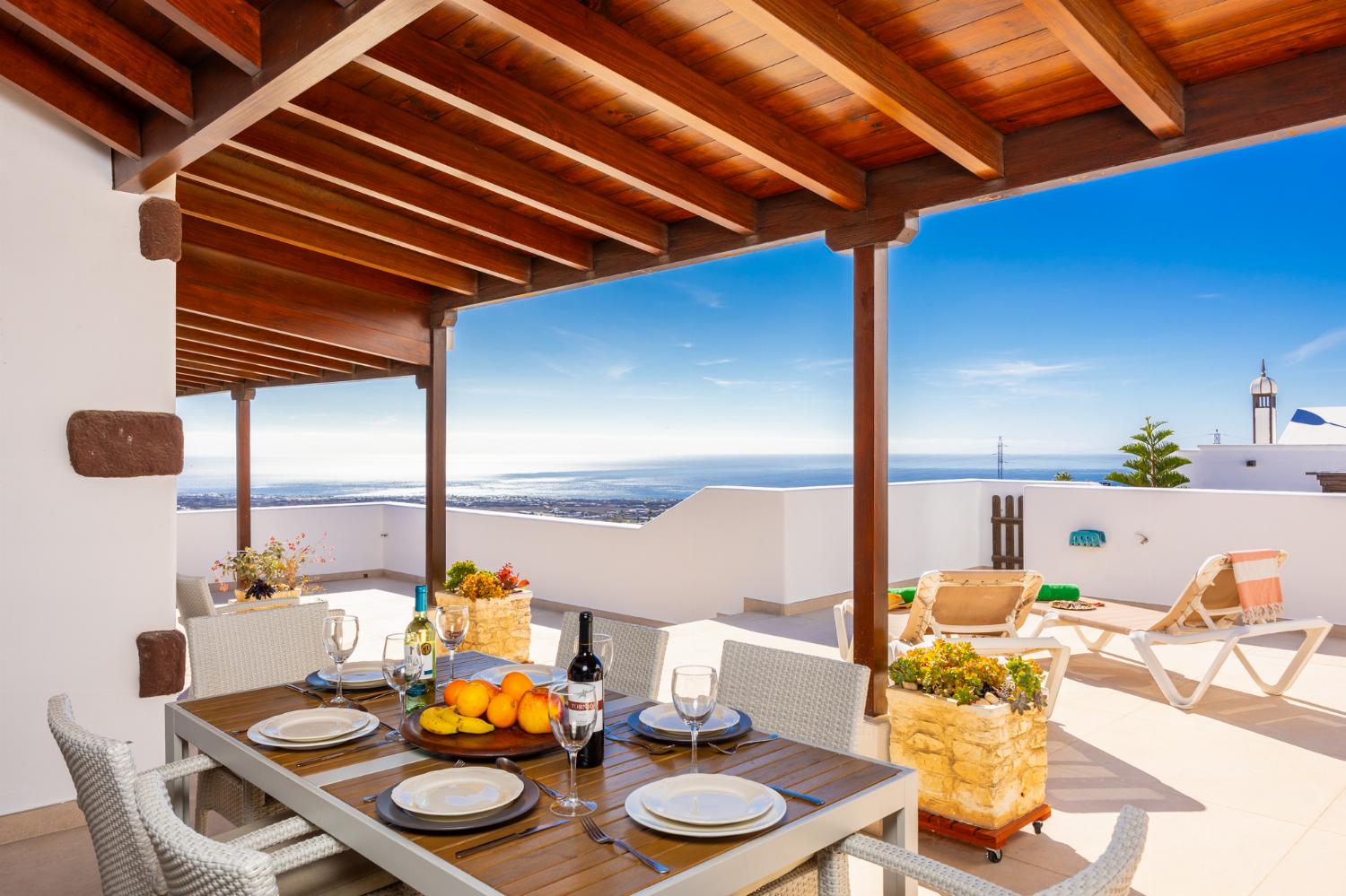 Sheltered upper terrace area with sea views