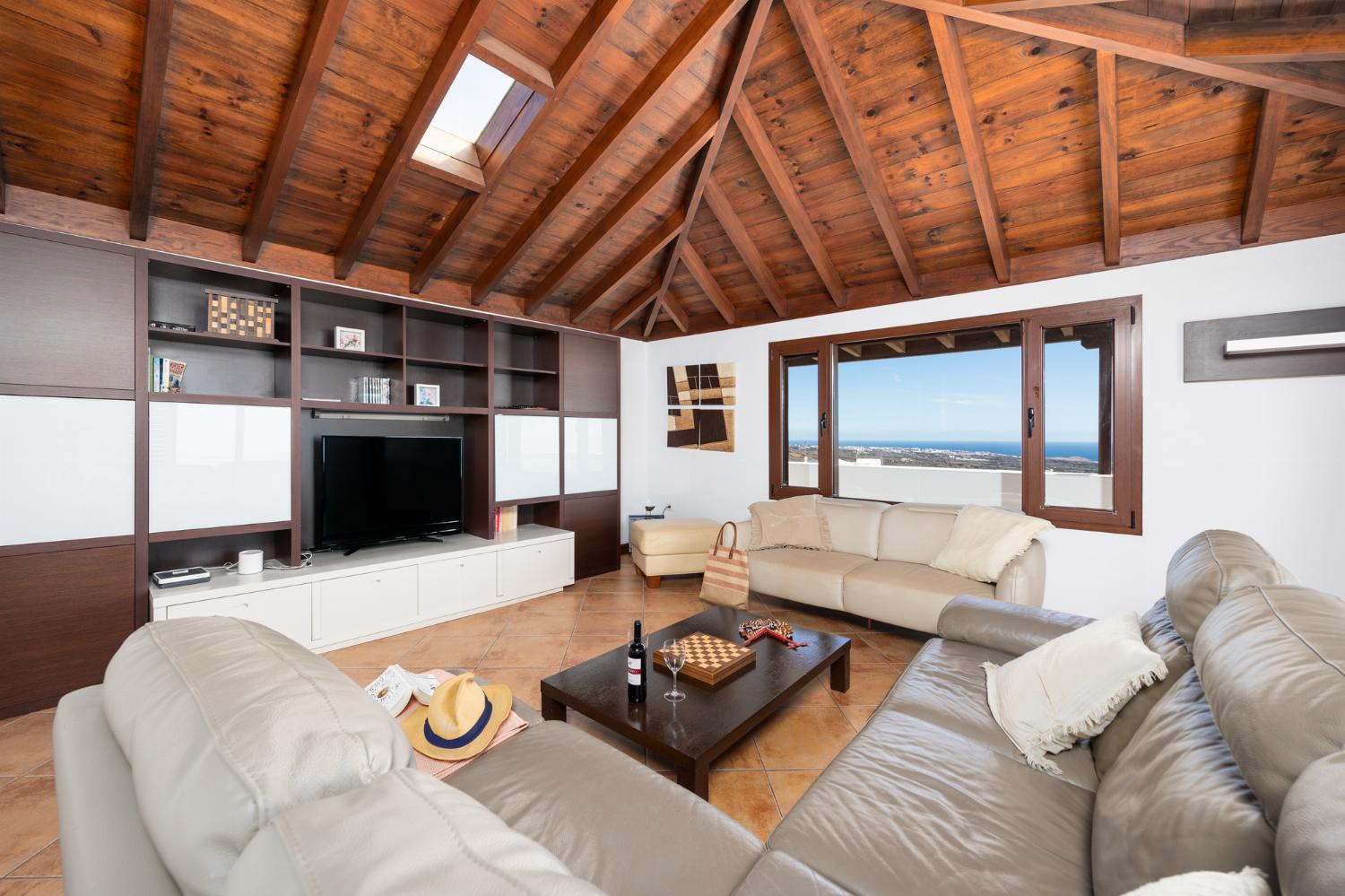 Living room with sofas, dining area, WiFi internet, satellite TV, and sea views