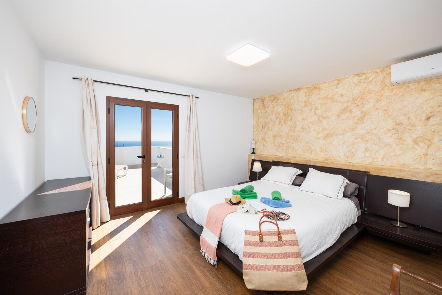 Double bedroom with en suite bathroom, A/C, and sea views