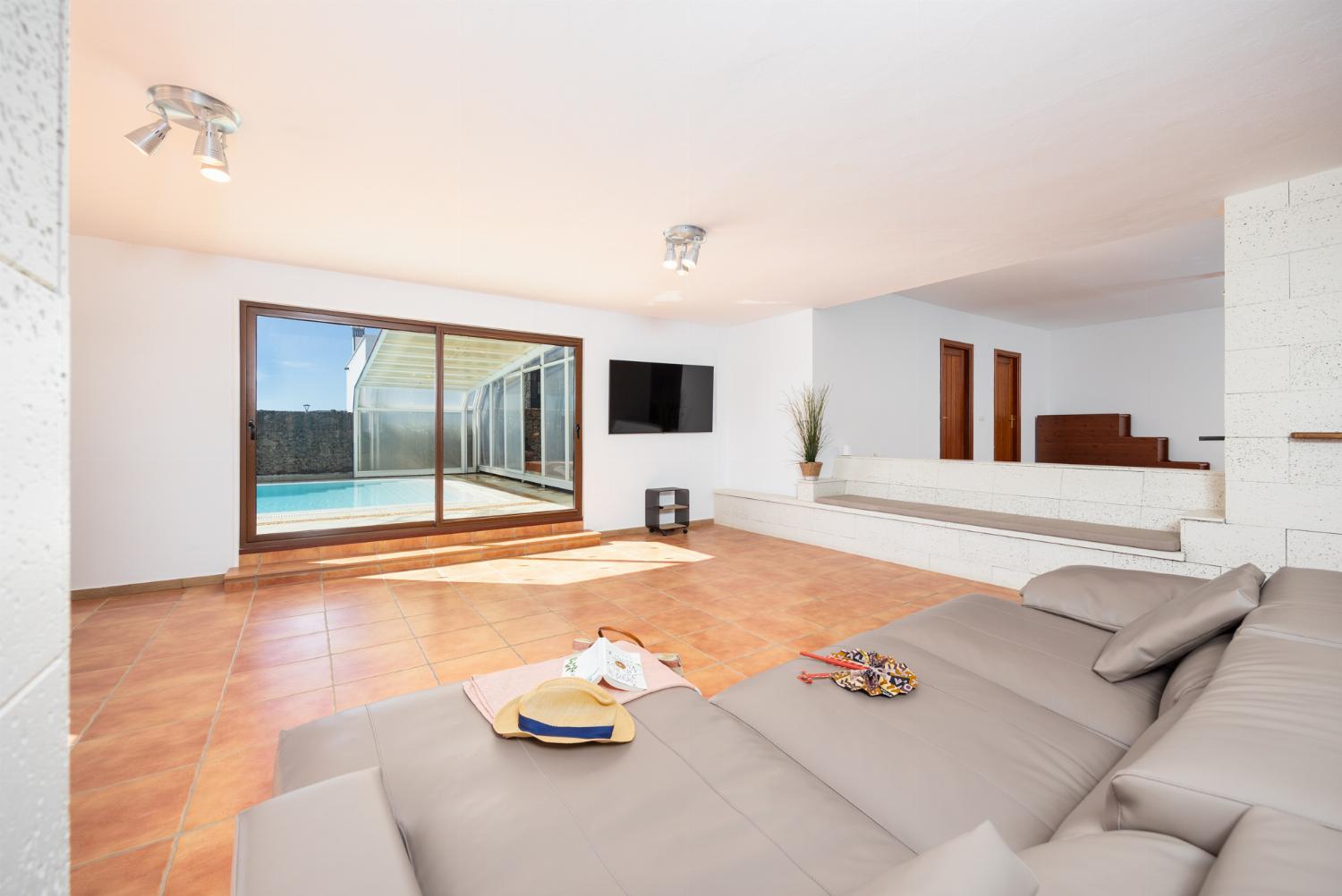 Living area with sofa, dining area, kitchenette, satellite TV, and sea views
