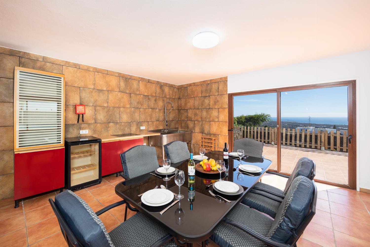Living area with sofa, dining area, kitchenette, satellite TV, and sea views