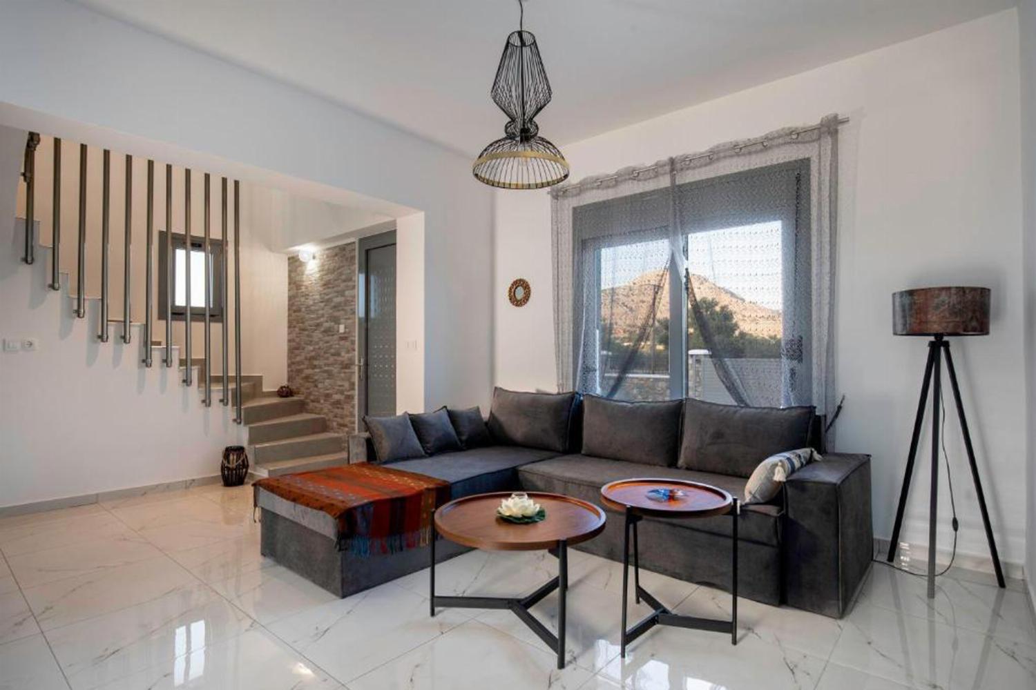 Open-plan living room with sofas, dining areas, kitchen