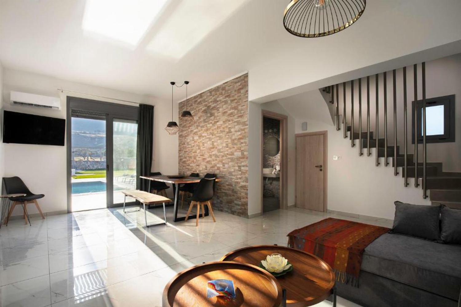 Open-plan living room with sofas, dining areas, kitchen