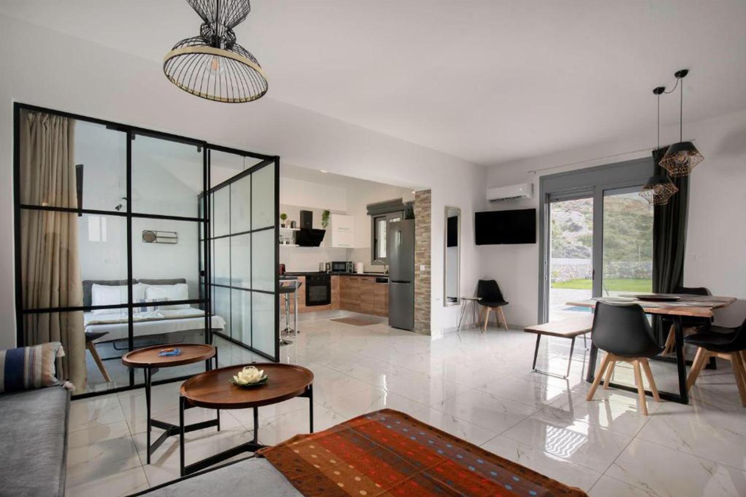 Open-plan living room with sofas, dining areas, kitchen