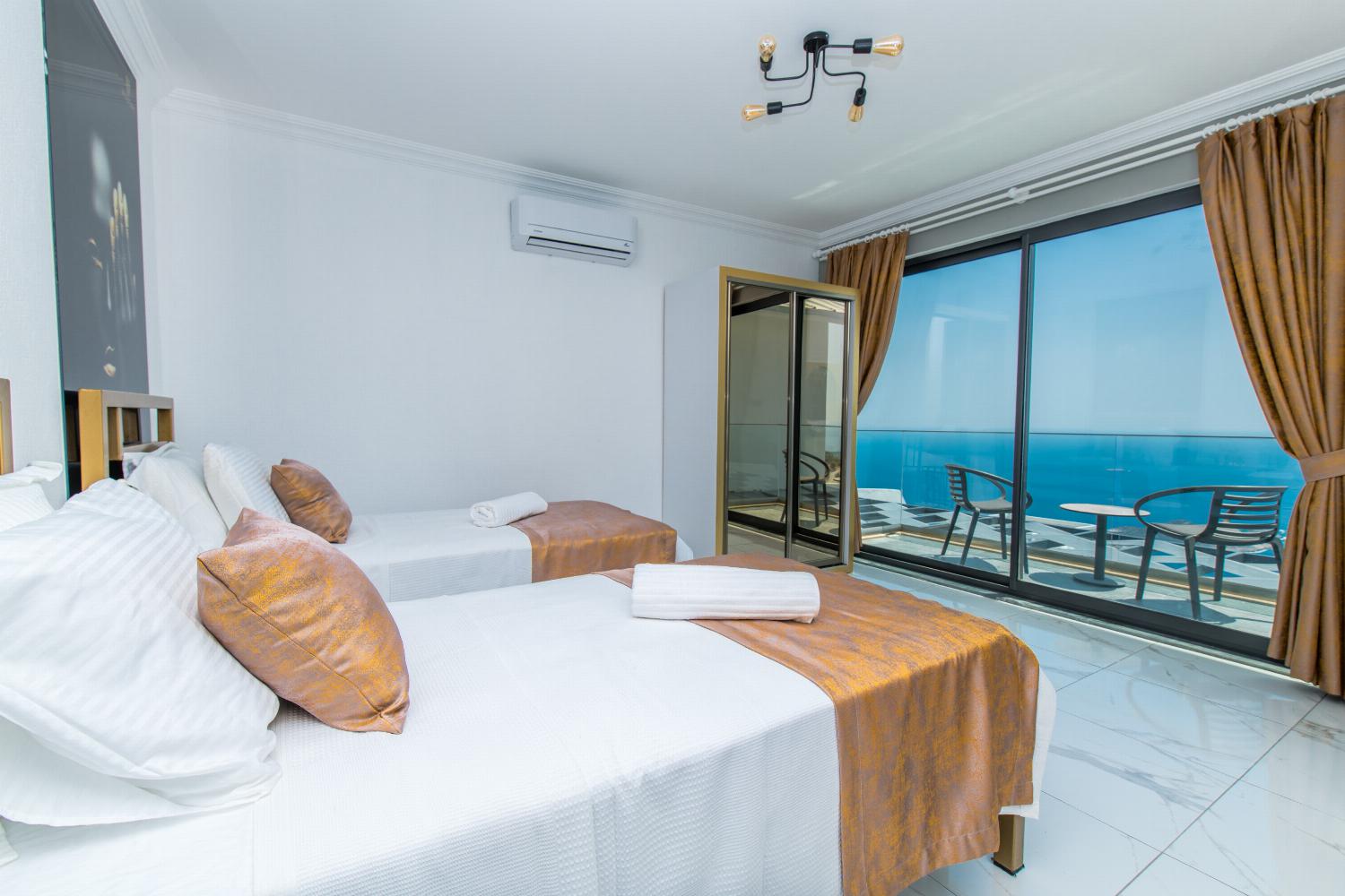 Twin bedroom with A/C, and upper terrace access with panoramic sea views