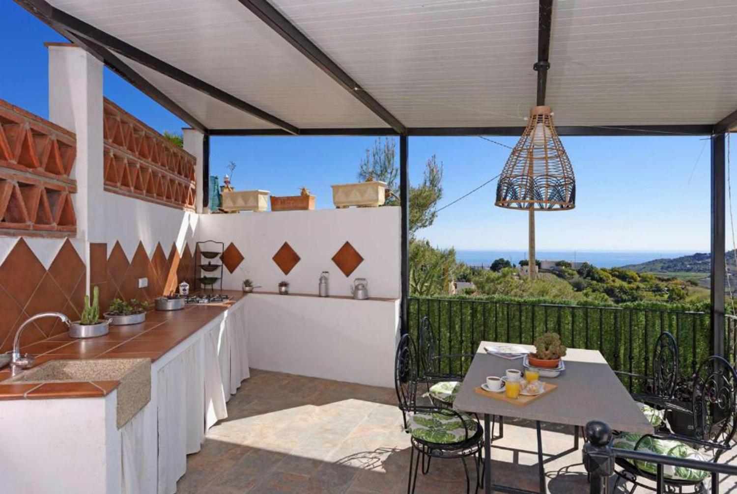 Outside area with garden sea view and BBQ
