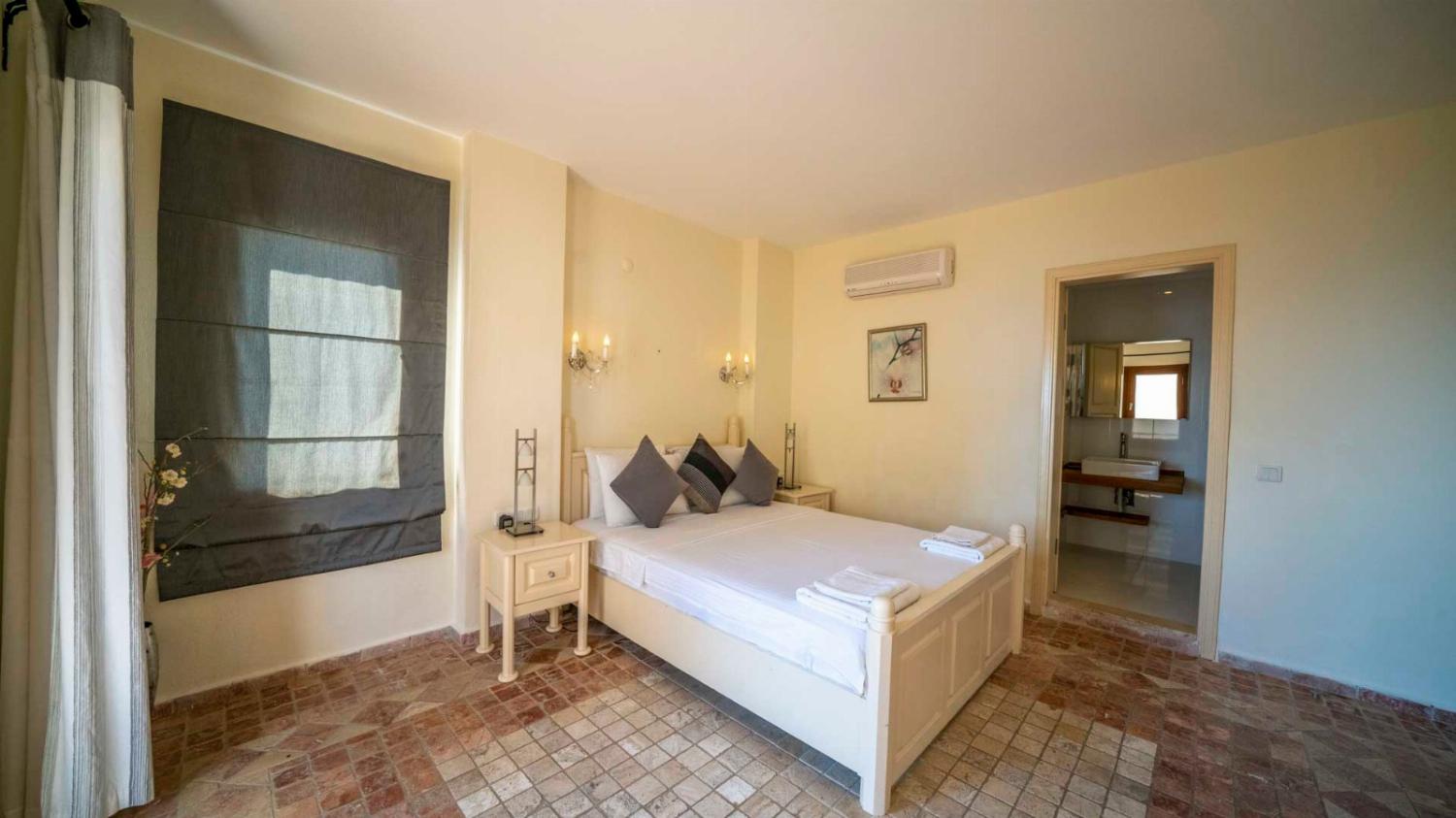 Double bedroom with en suite bathroom, A/C, and upper terrace access 
