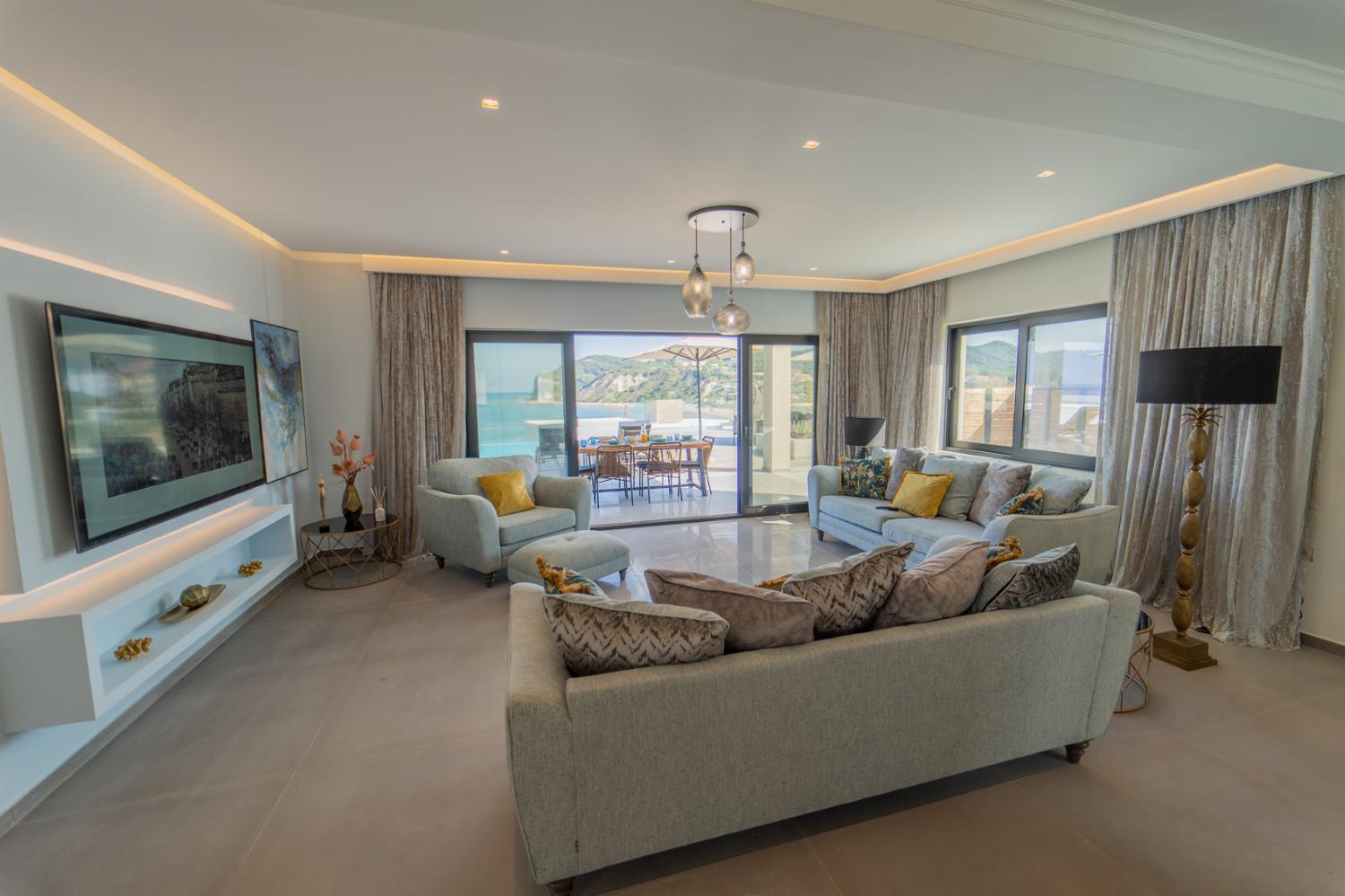 Open-plan living room with sofa, dining area, kitchen, WiFi internet, satellite TV, and sea views