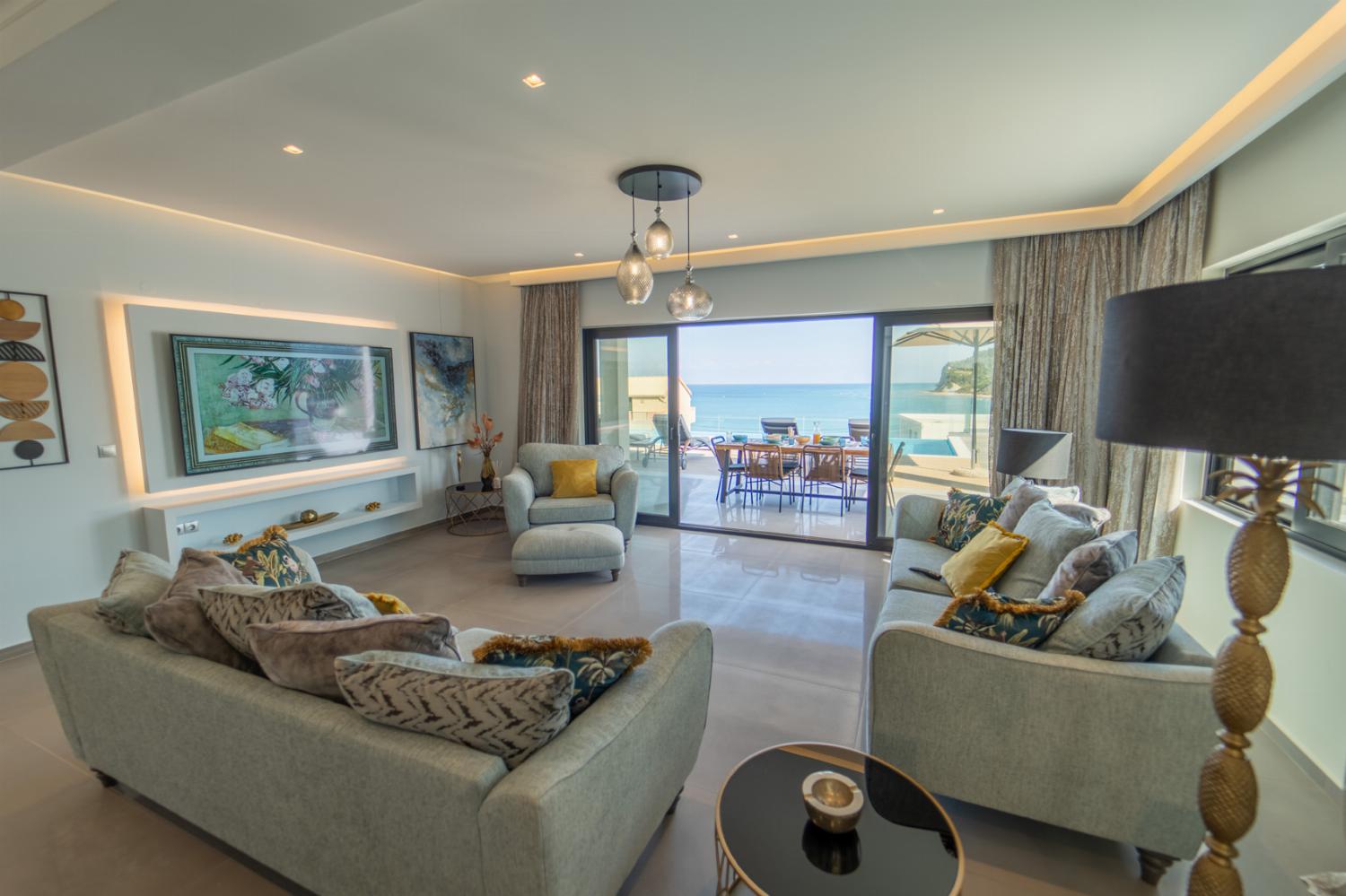 Open-plan living room with sofa, dining area, kitchen, WiFi internet, satellite TV, and sea views