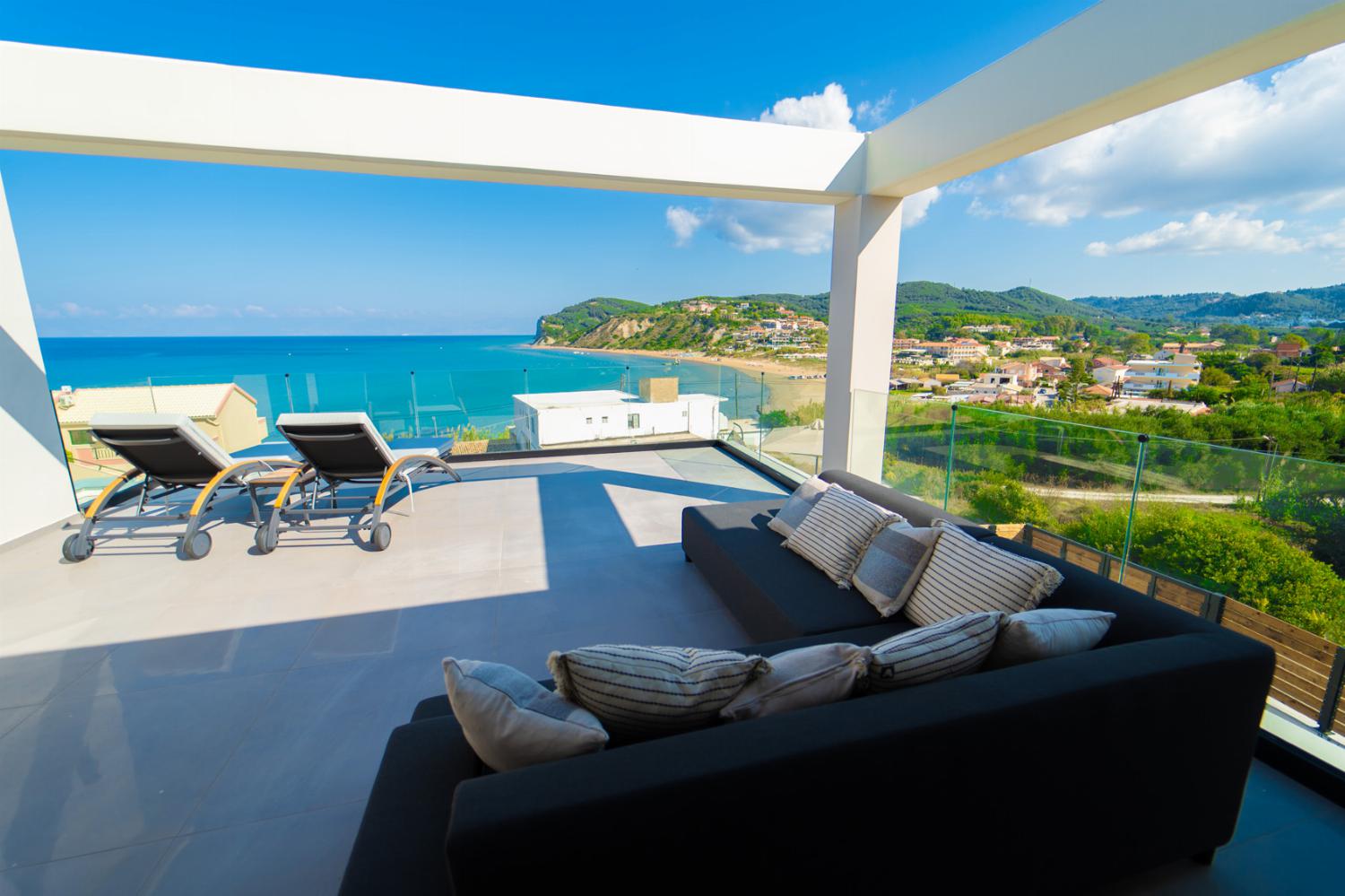 Upper terrasse with sunbeds and sitting area
