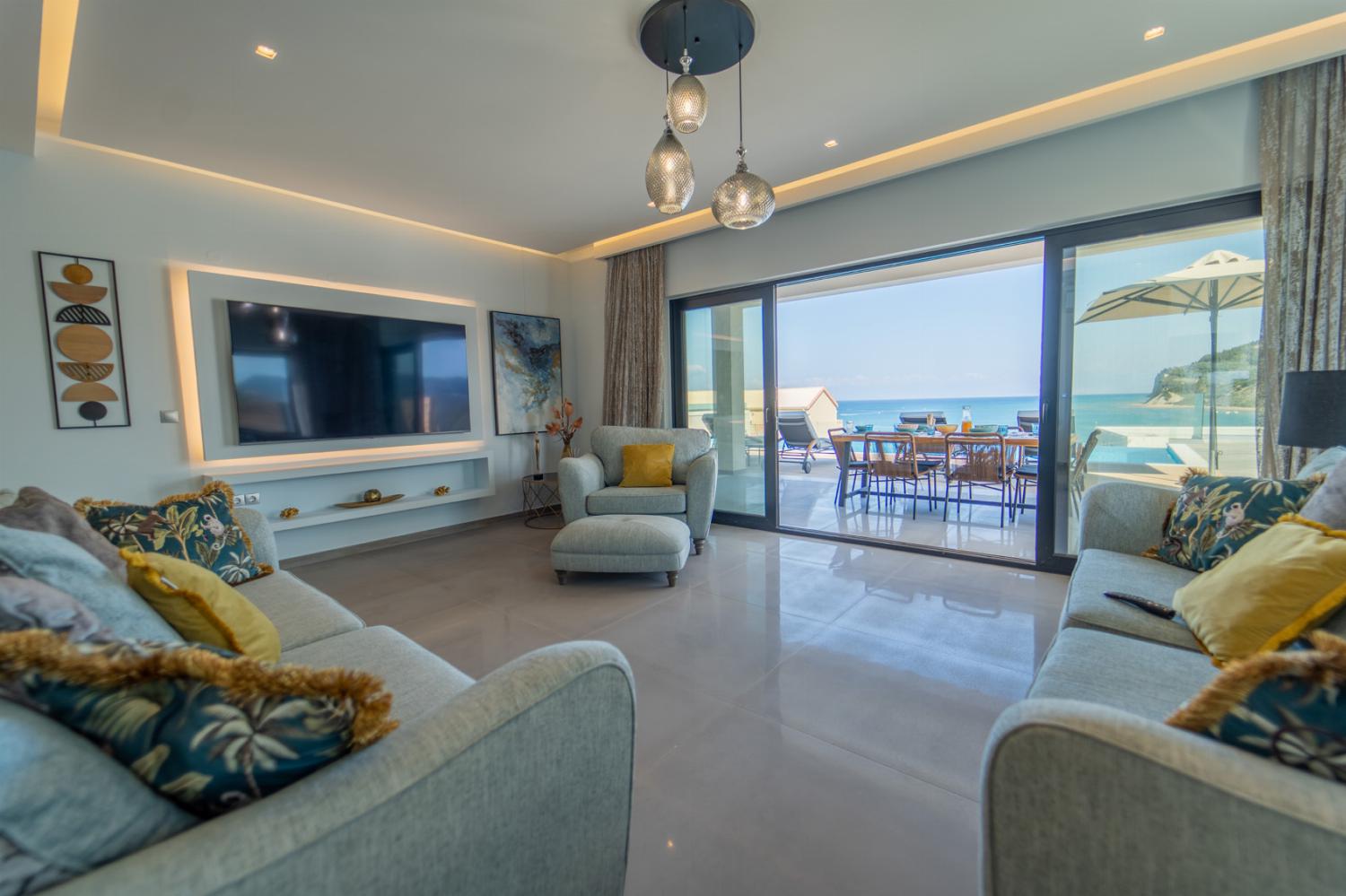 Open-plan living room with sofa, dining area, kitchen, WiFi internet, satellite TV, and sea views