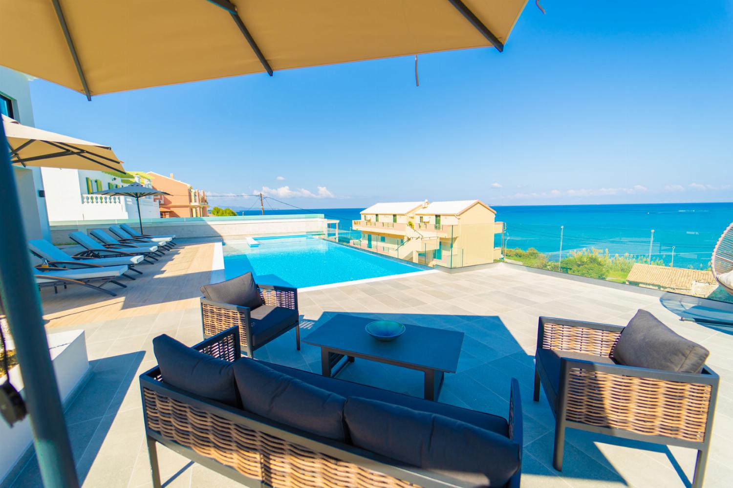 Outdoors sitting area with private pool and panoramic sea view 