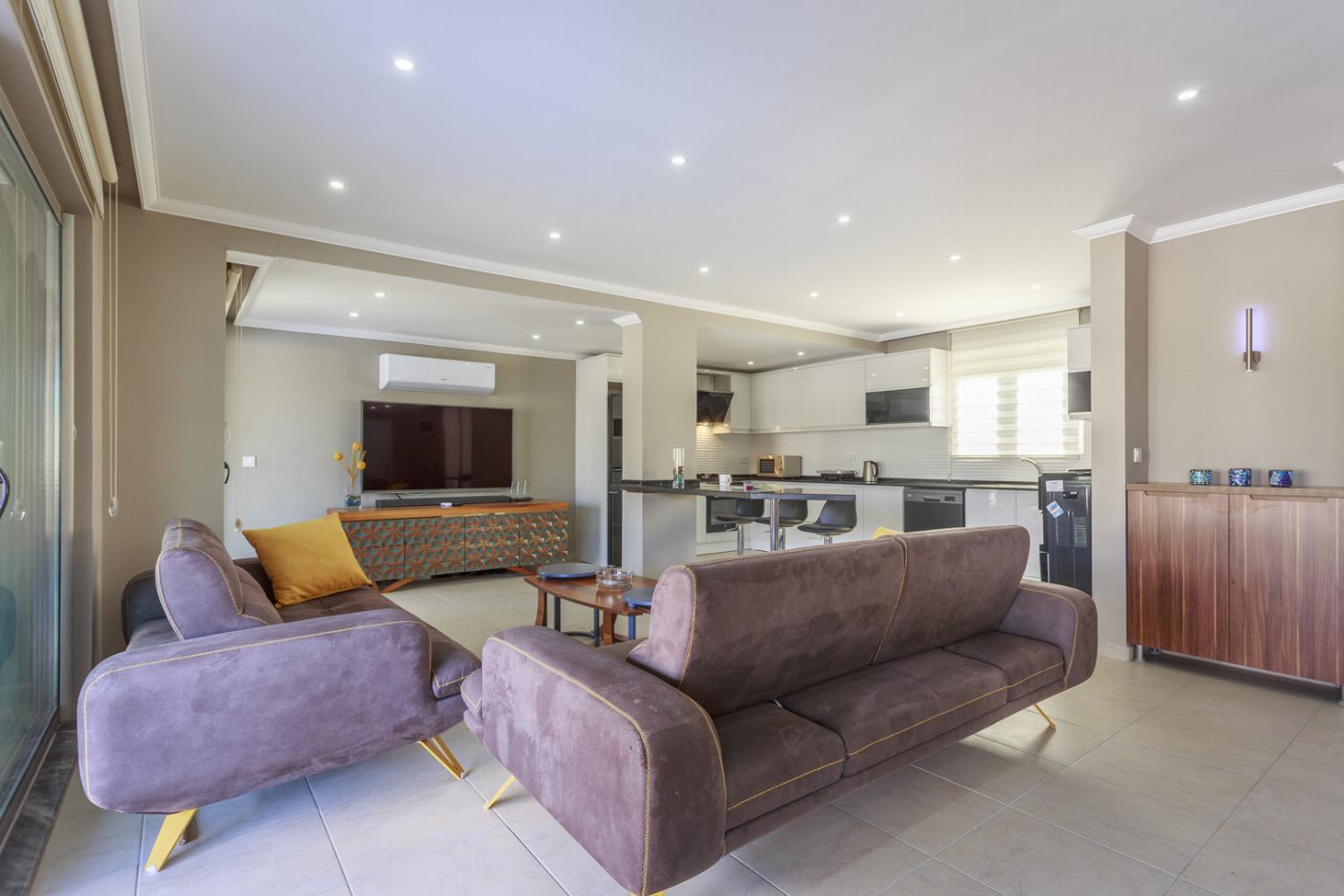 Open-plan living room with sofas, dining area