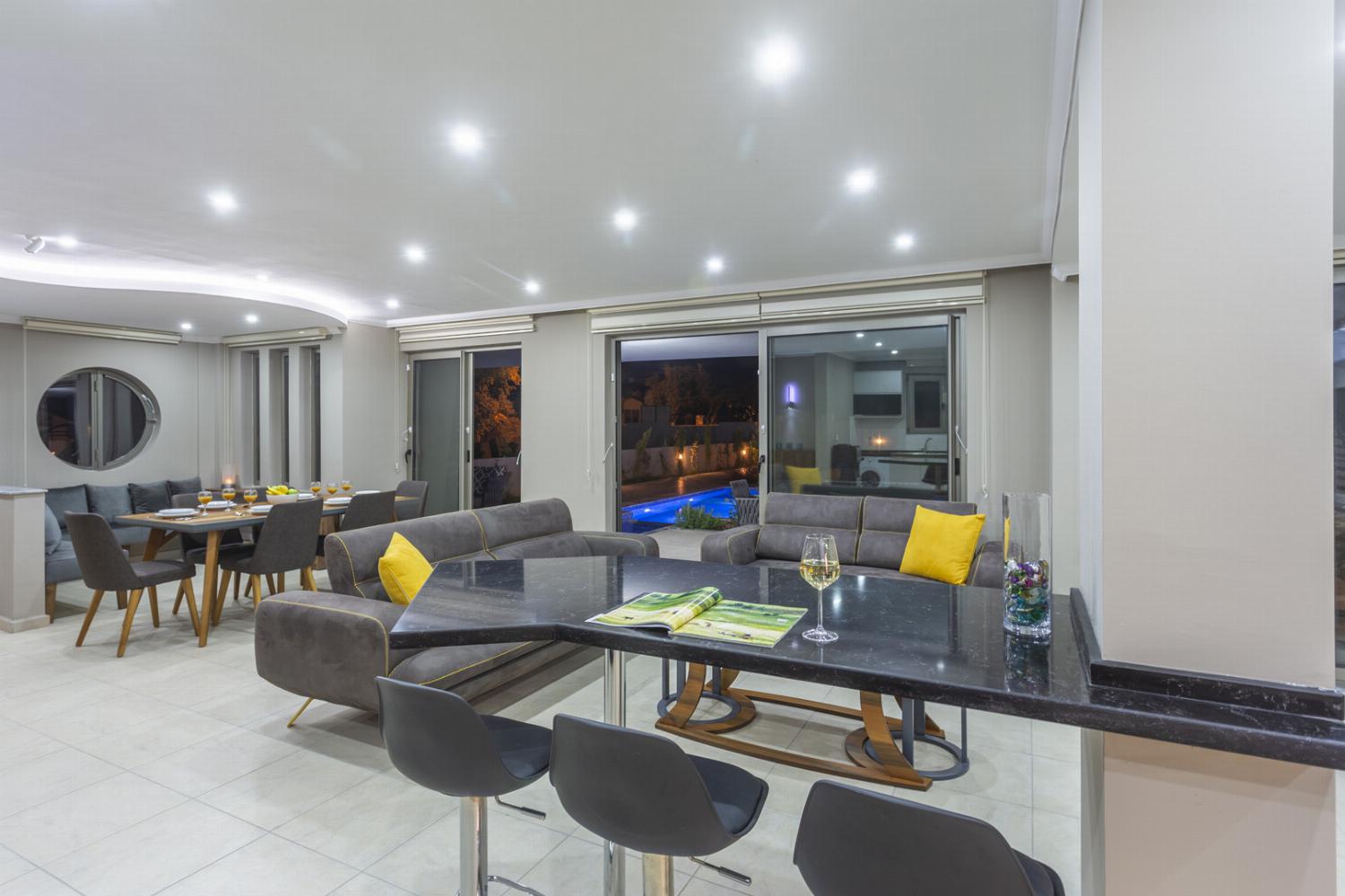Open-plan living room with sofas, dining area
