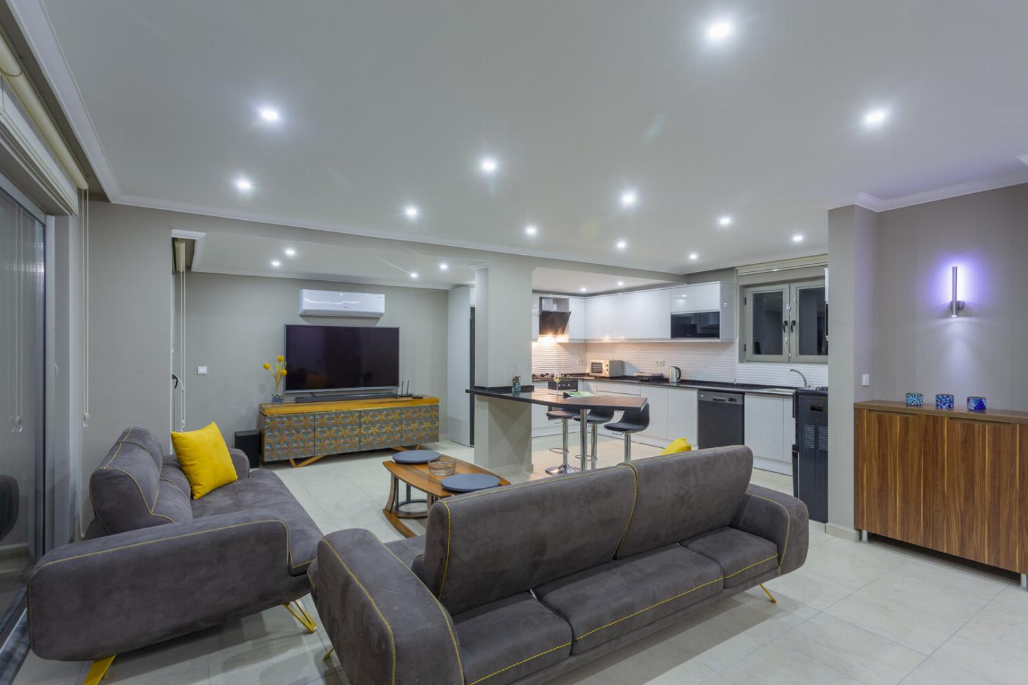 Open-plan living room with sofas, dining area