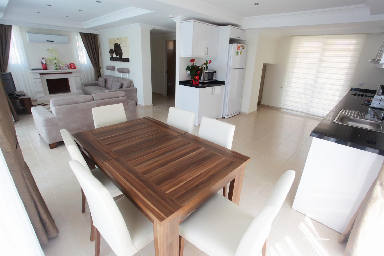 Open-plan living room with comfortable sofas, ornamental fireplace, WiFi, TV