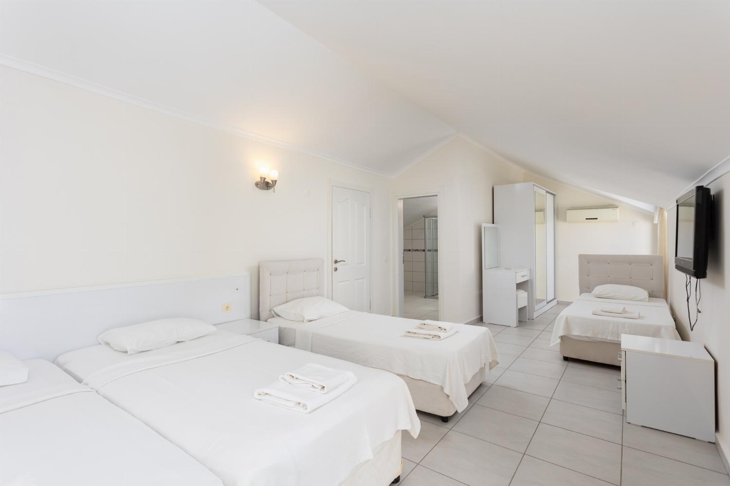 Bedroom with 4 single beds, en suite bathroom, and A/C