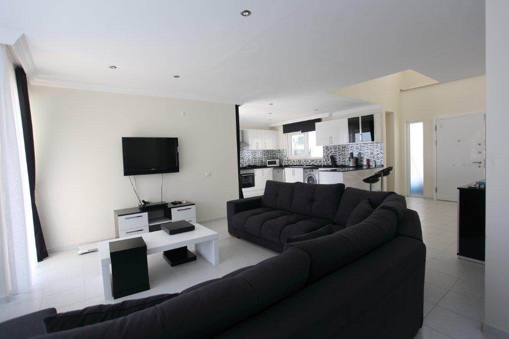 Open-plan living room with comfortable sitting, WiFi, TV, dining area
