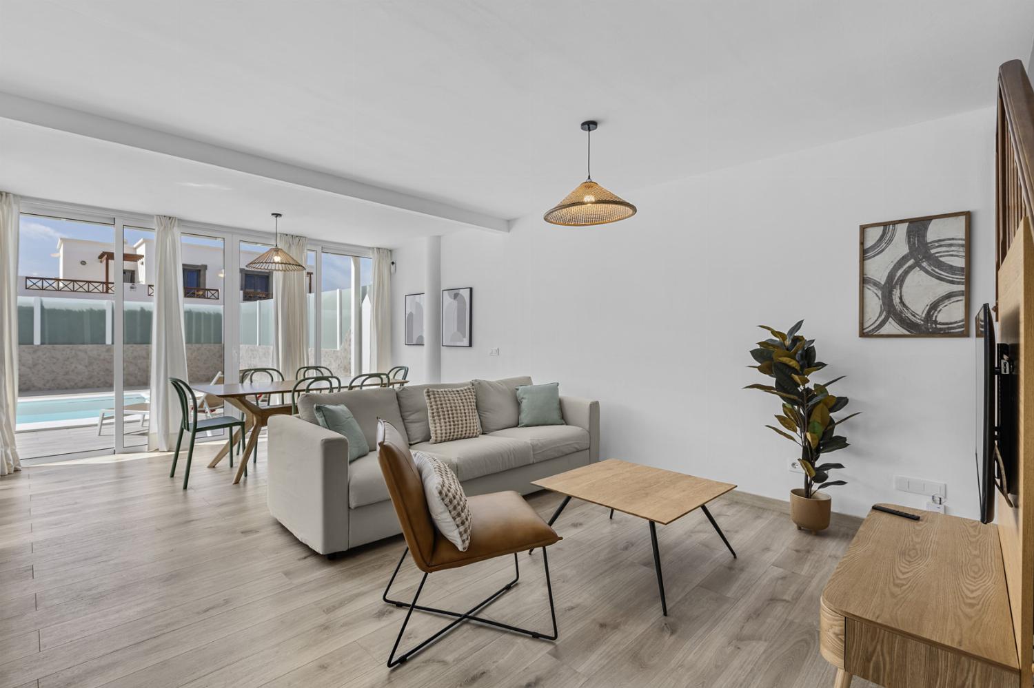 ,Open-plan living room with sofas, dining area, kitchen, WiFi internet, satellite TV