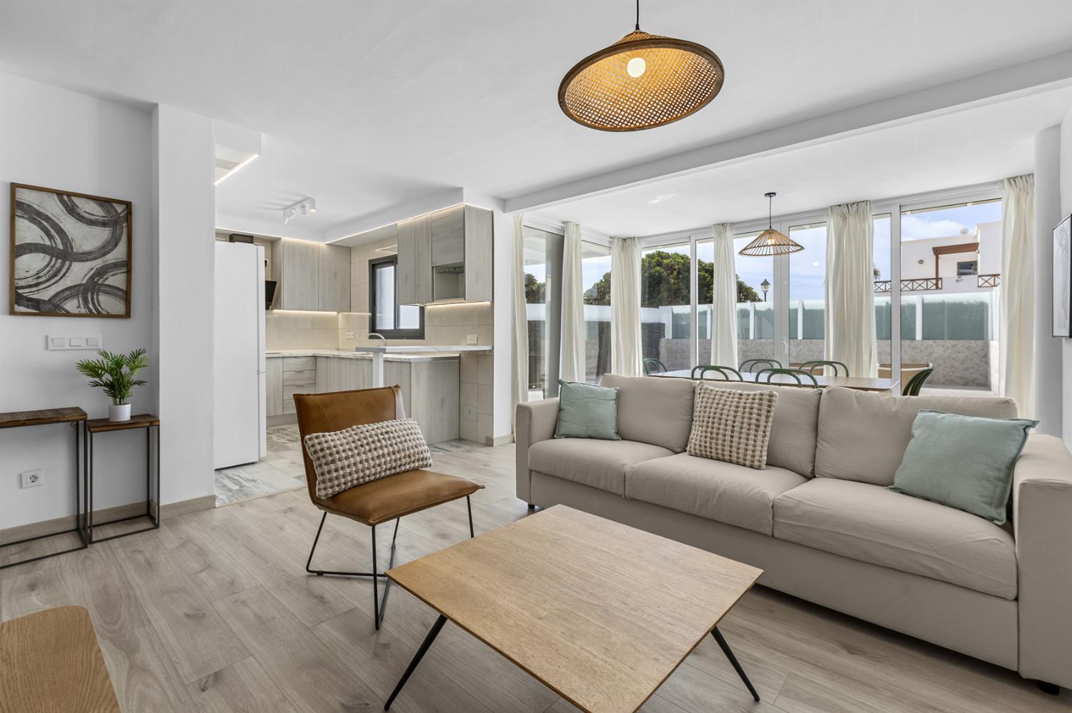 ,Open-plan living room with sofas, dining area, kitchen, WiFi internet, satellite TV