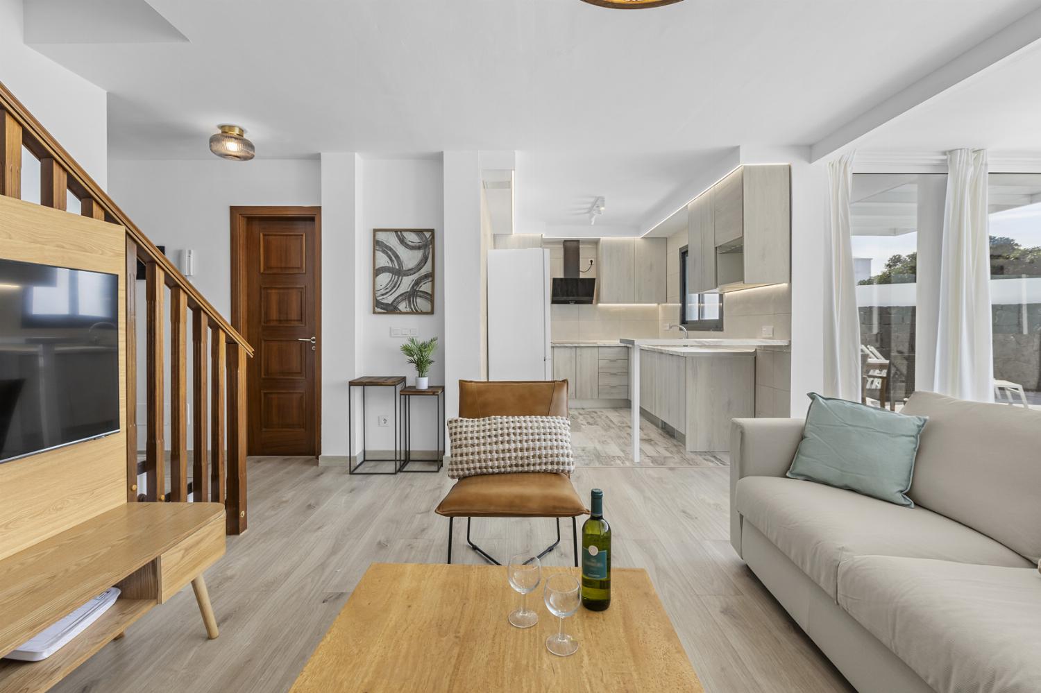,Open-plan living room with sofas, dining area, kitchen, WiFi internet, satellite TV