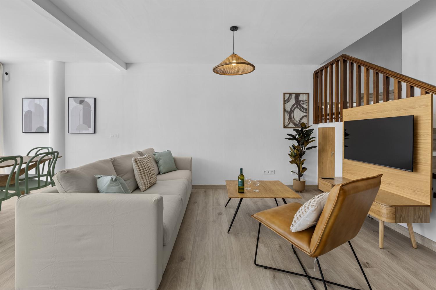 Open-plan living room with sofas, dining area, kitchen, WiFi internet, satellite TV
